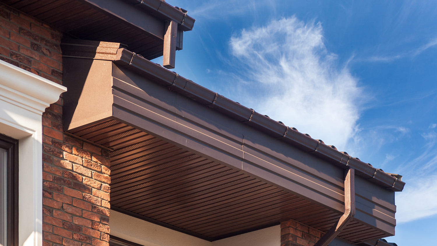 Brown rain gutter on modern brick home
