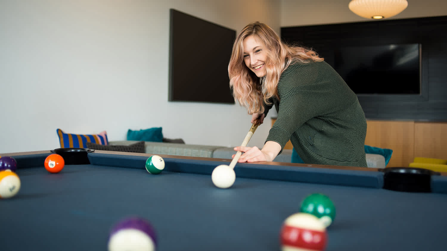 woman playing pool at home