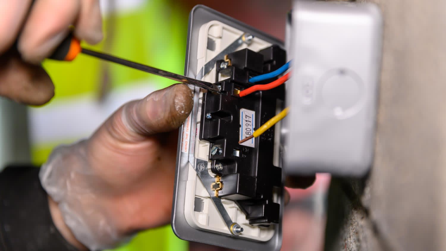 Male hands wiring a socket plug on garage