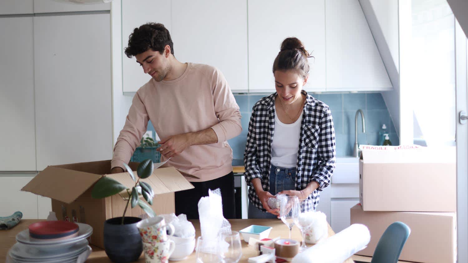 Couple packing moving boxes