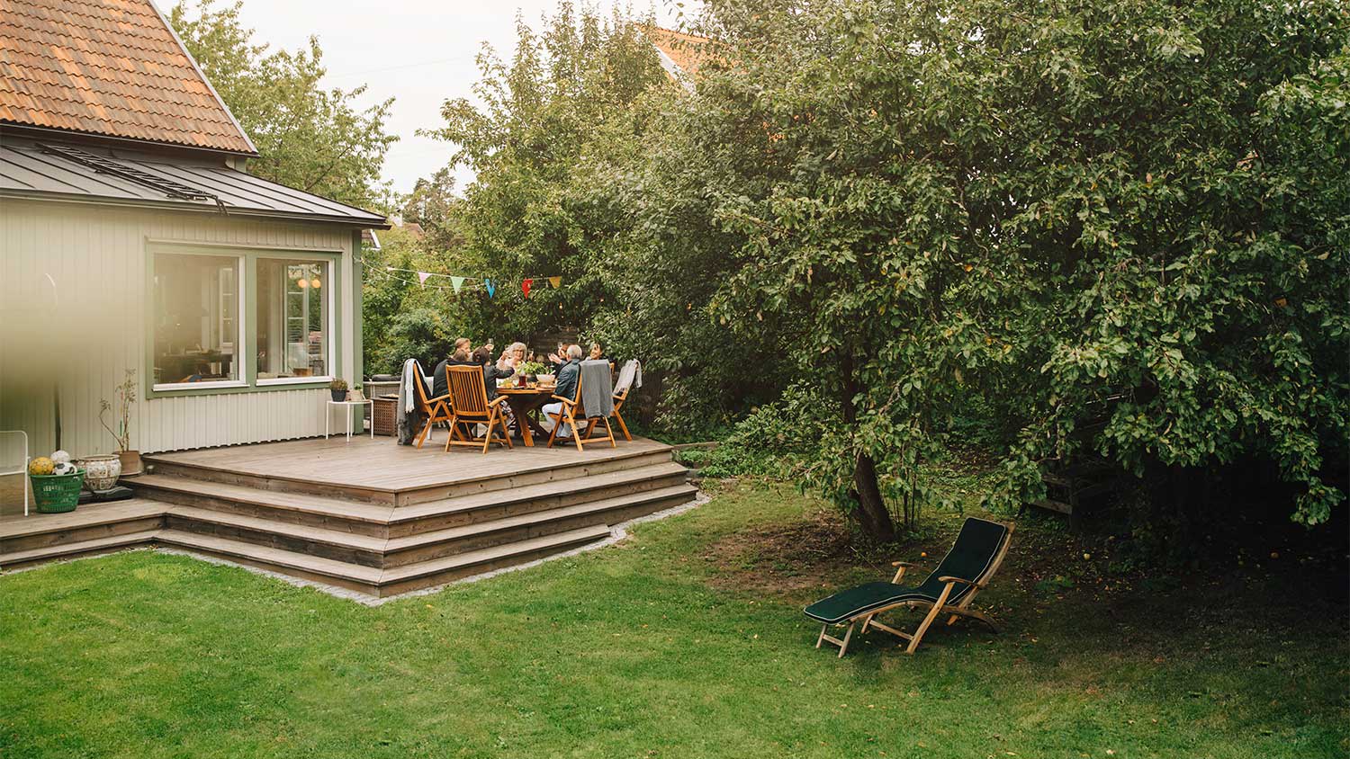 A family eats on a wooden deck