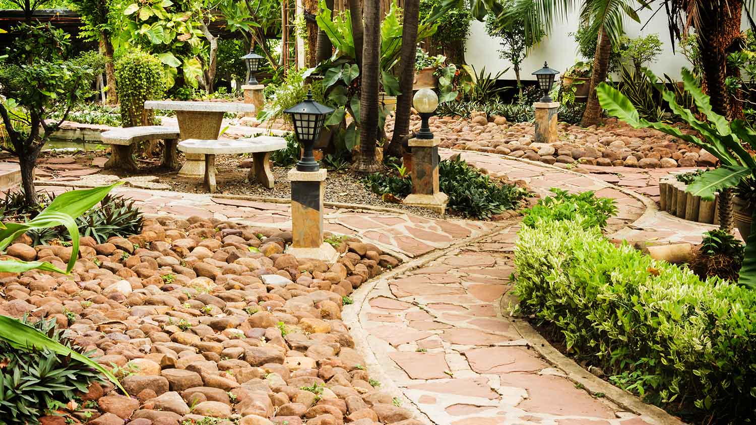 Garden with stone pathway and concrete furniture