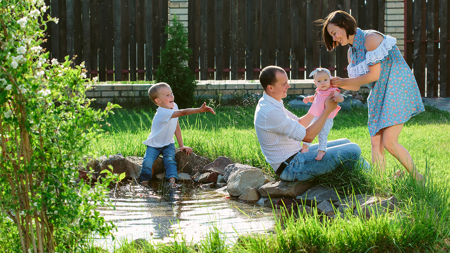 family playing by private pond
