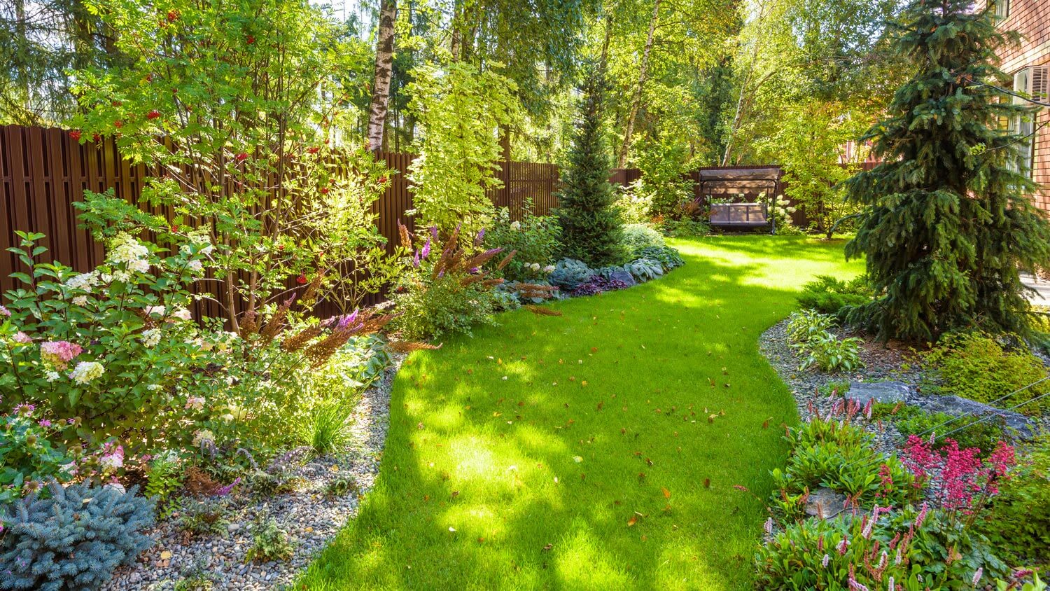 A backyard of a house with a lush garden