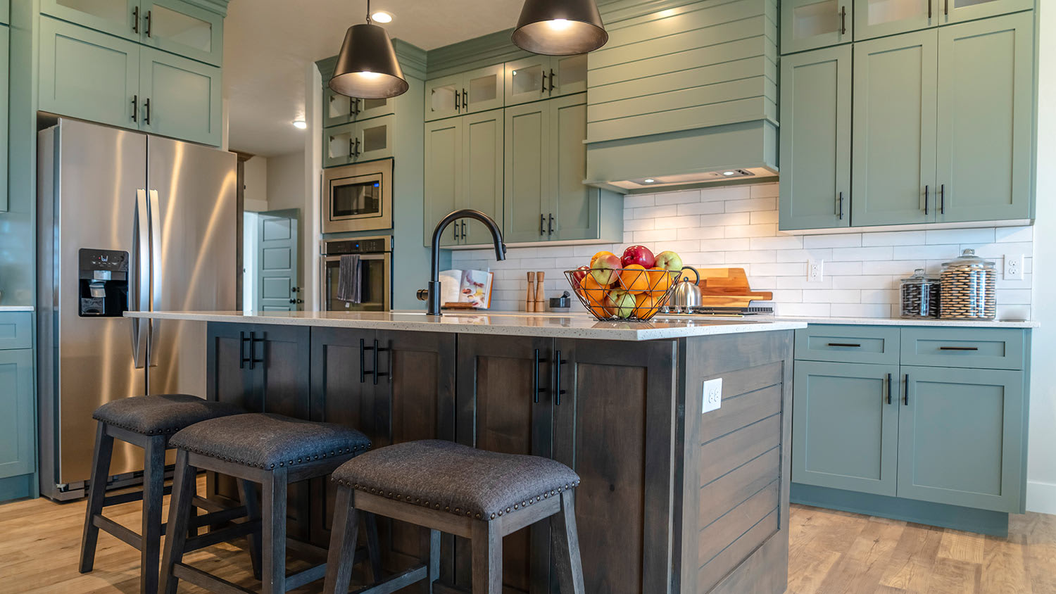 Kitchen island with stools against cabinets