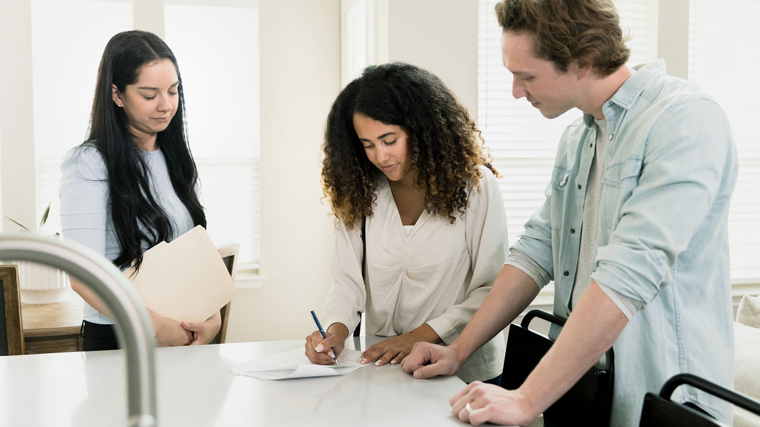 Couple signing new home purchasing documents