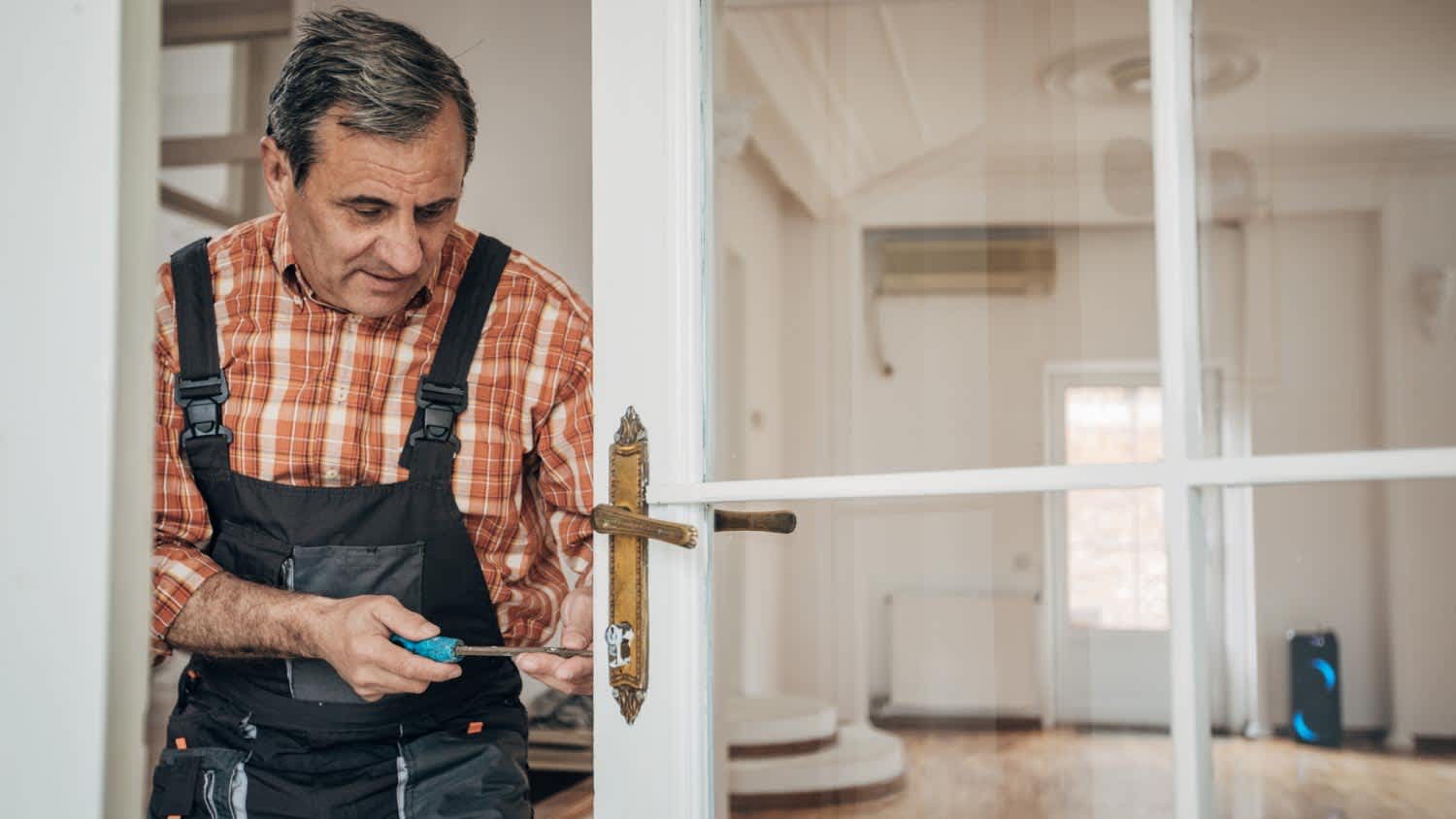A carpenter repairing the door