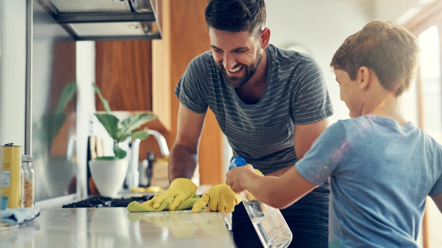 Father and son cleaning the kitchen