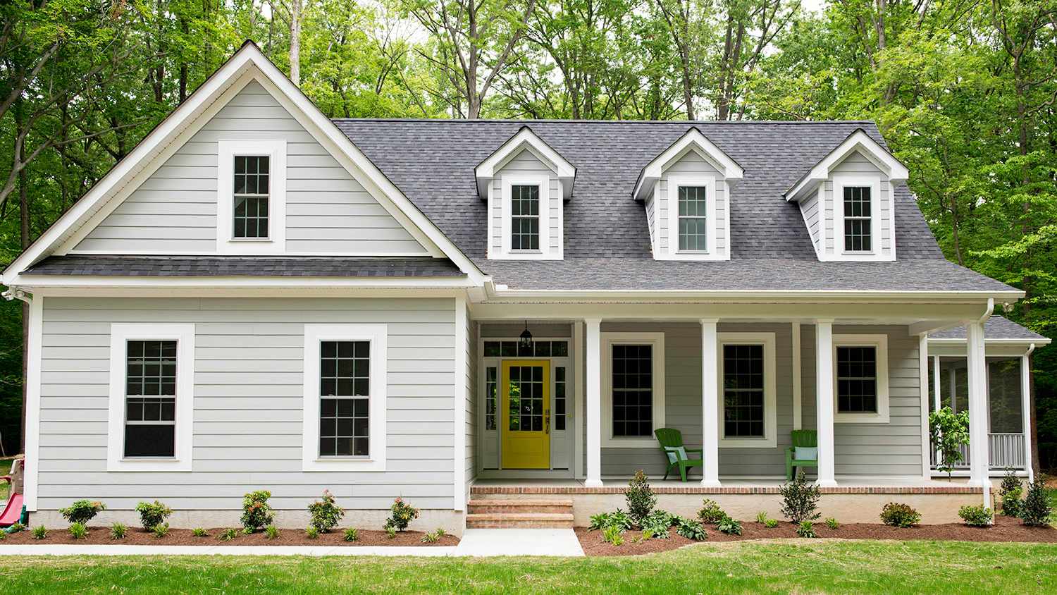 white and grey house with dormers