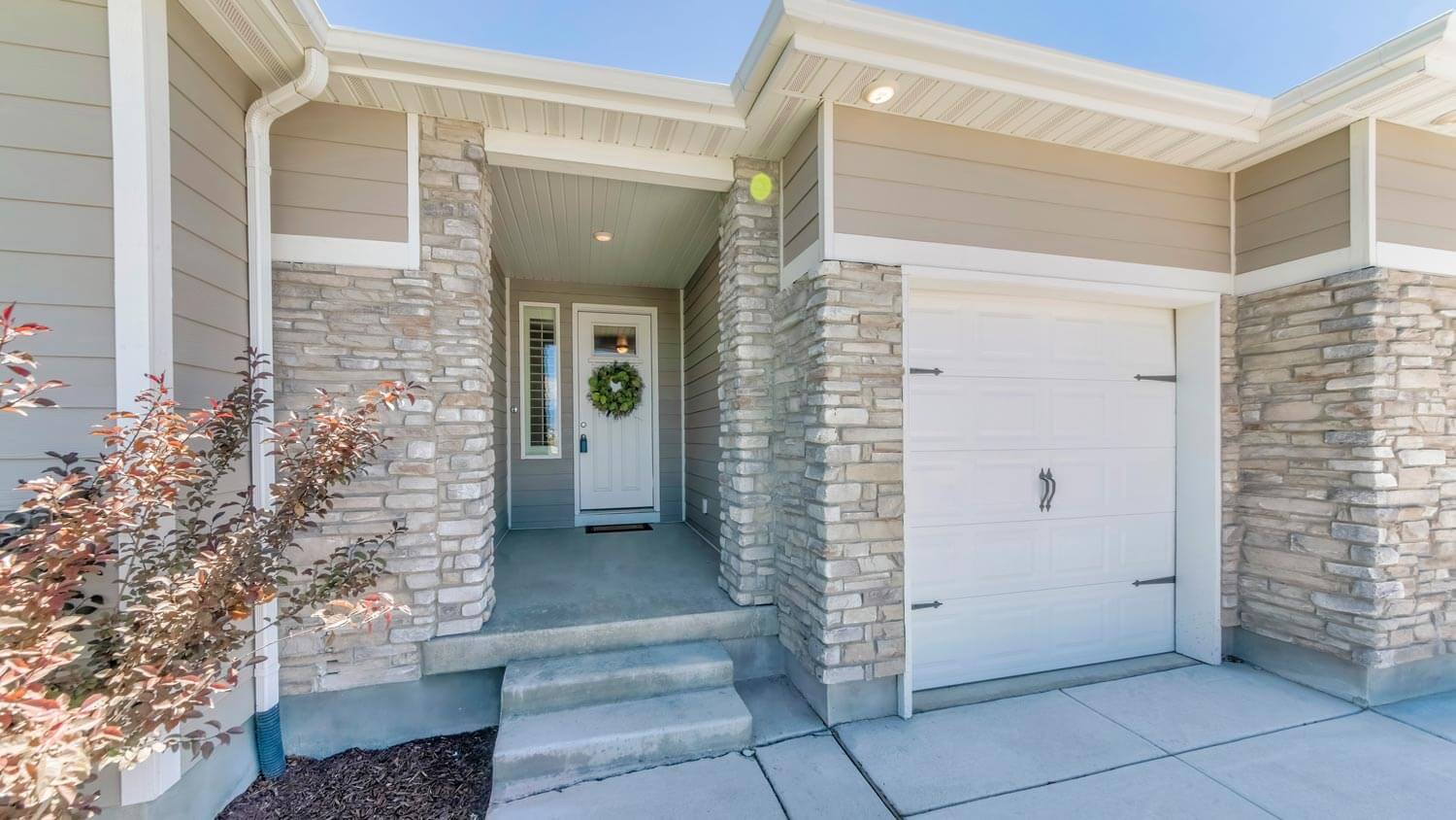A house entrance with stone veneer siding