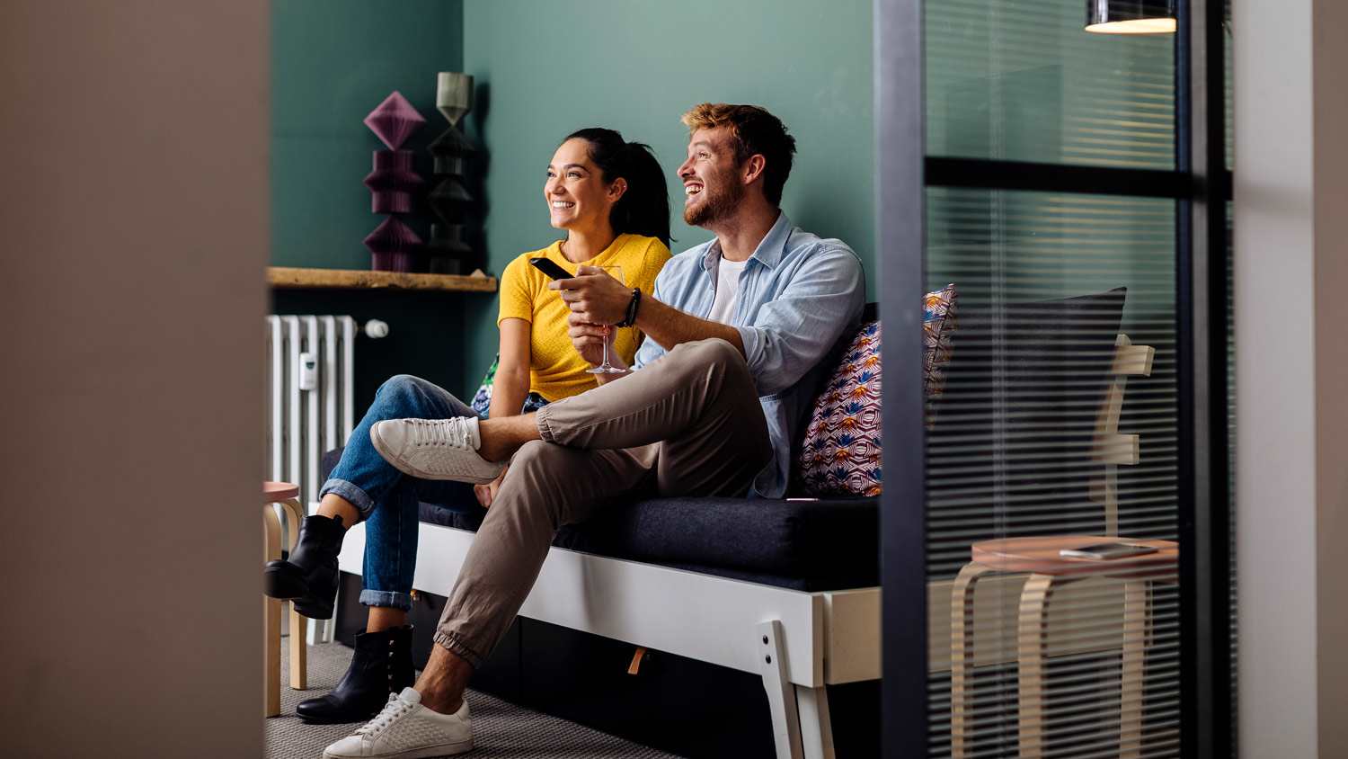 A couple watching tv in their living room