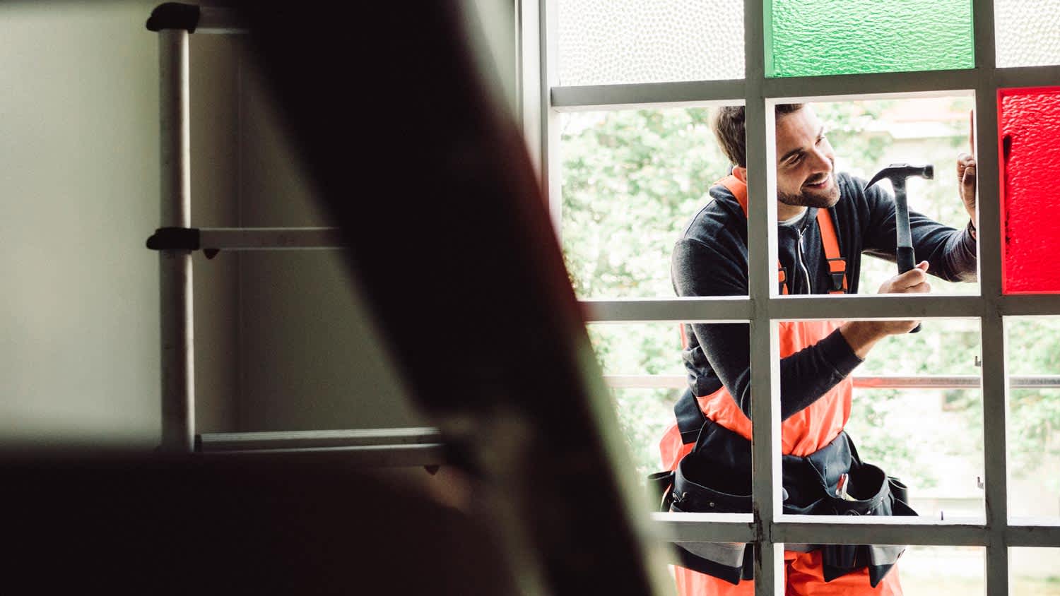 A man repairing a stained glass window