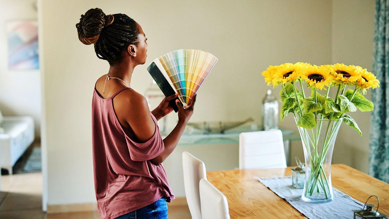 A woman holds paint swatches