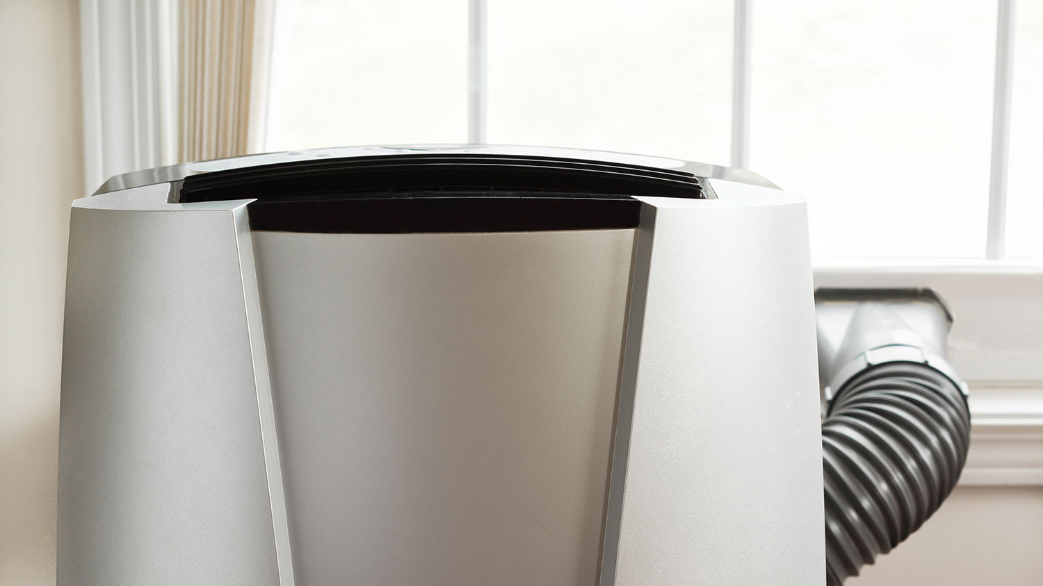 Portable air conditioner in front of a window