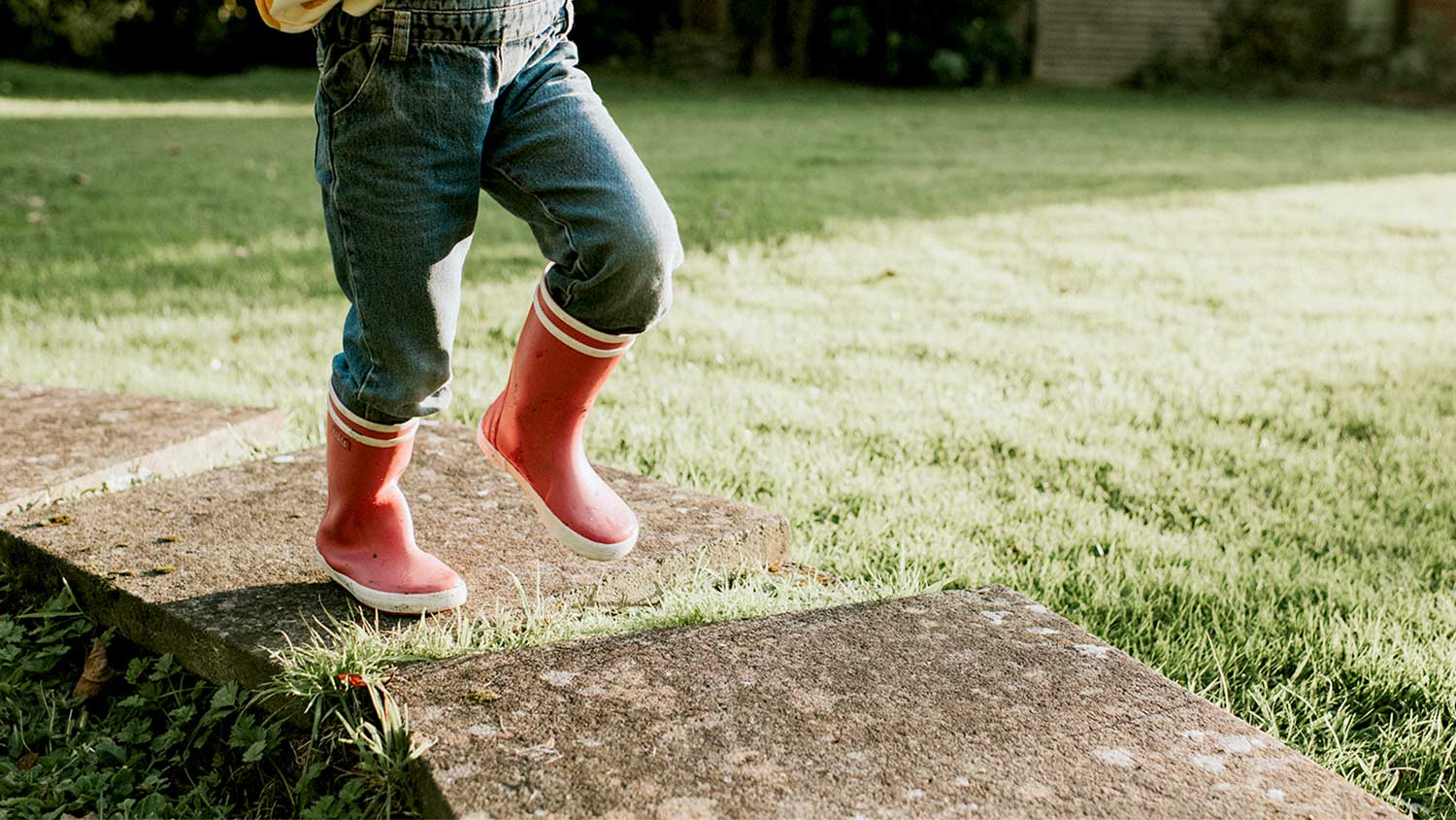 A child walks on pavers