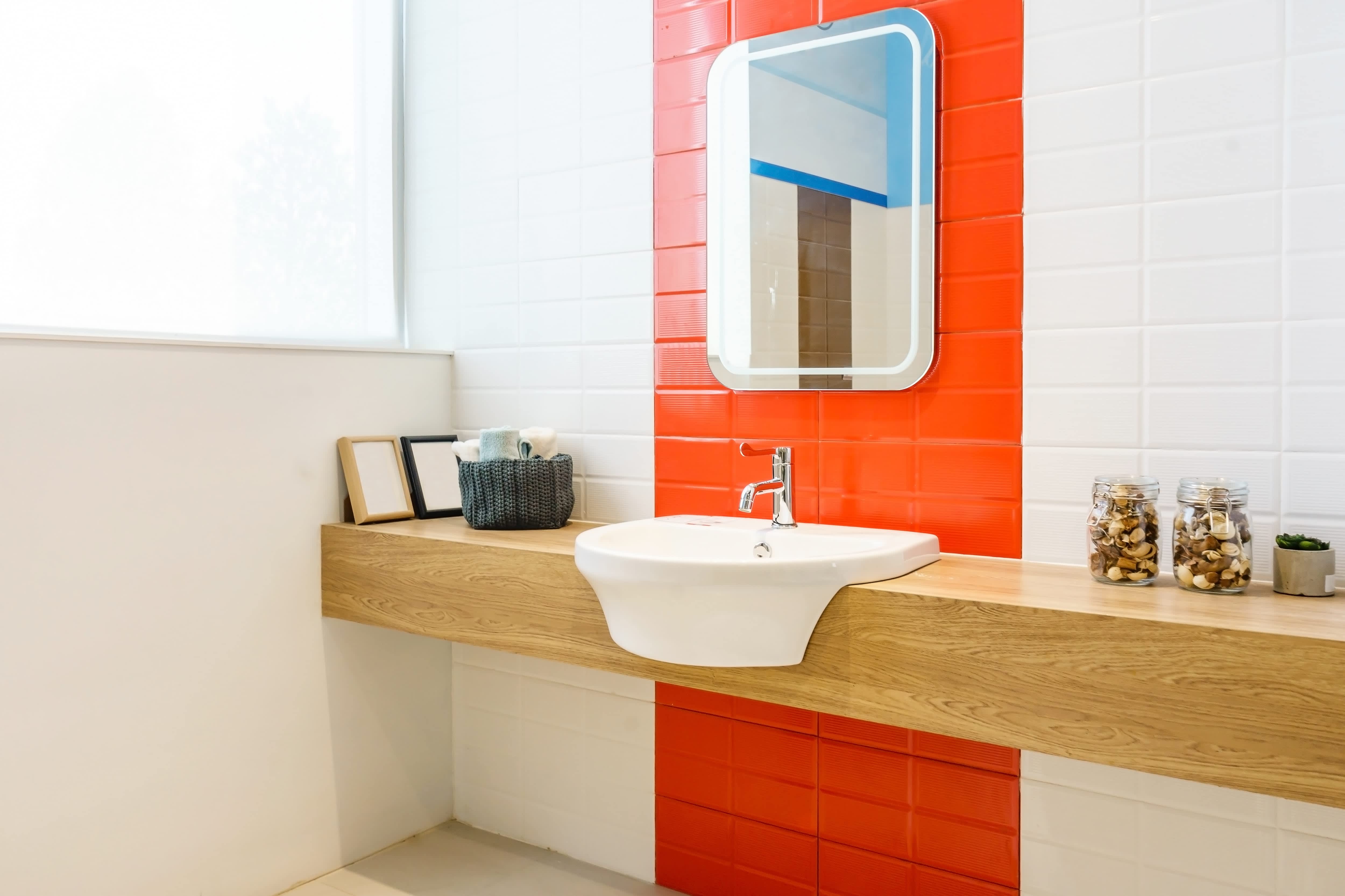 Modern powder room with floating vanity, square mirror, and lots of natural light