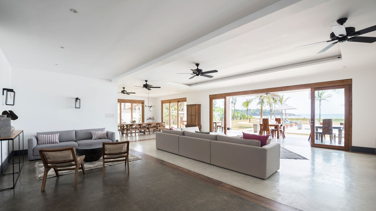 Open plan living area with ceiling fans and ocean view
