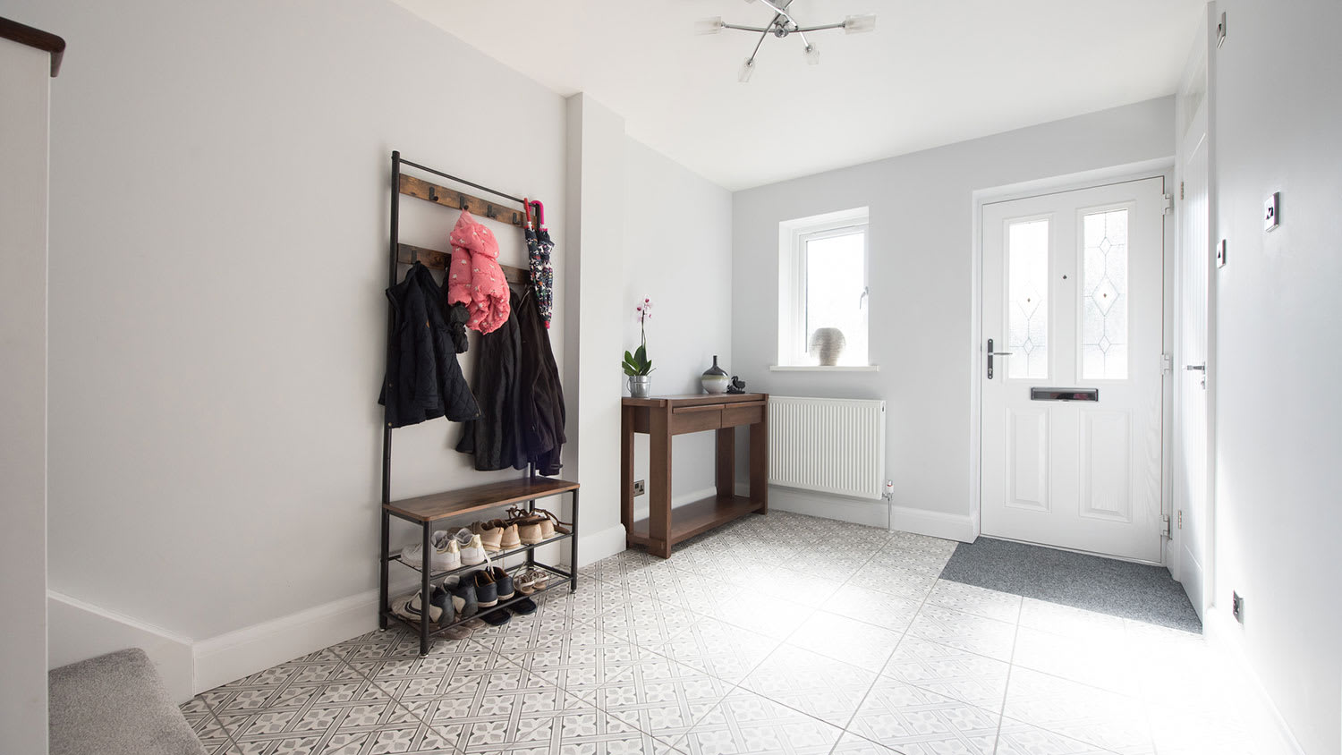 Neat house entryway with coat and shoe rack