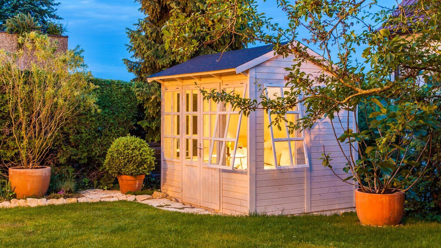 A garden shed illuminated at night