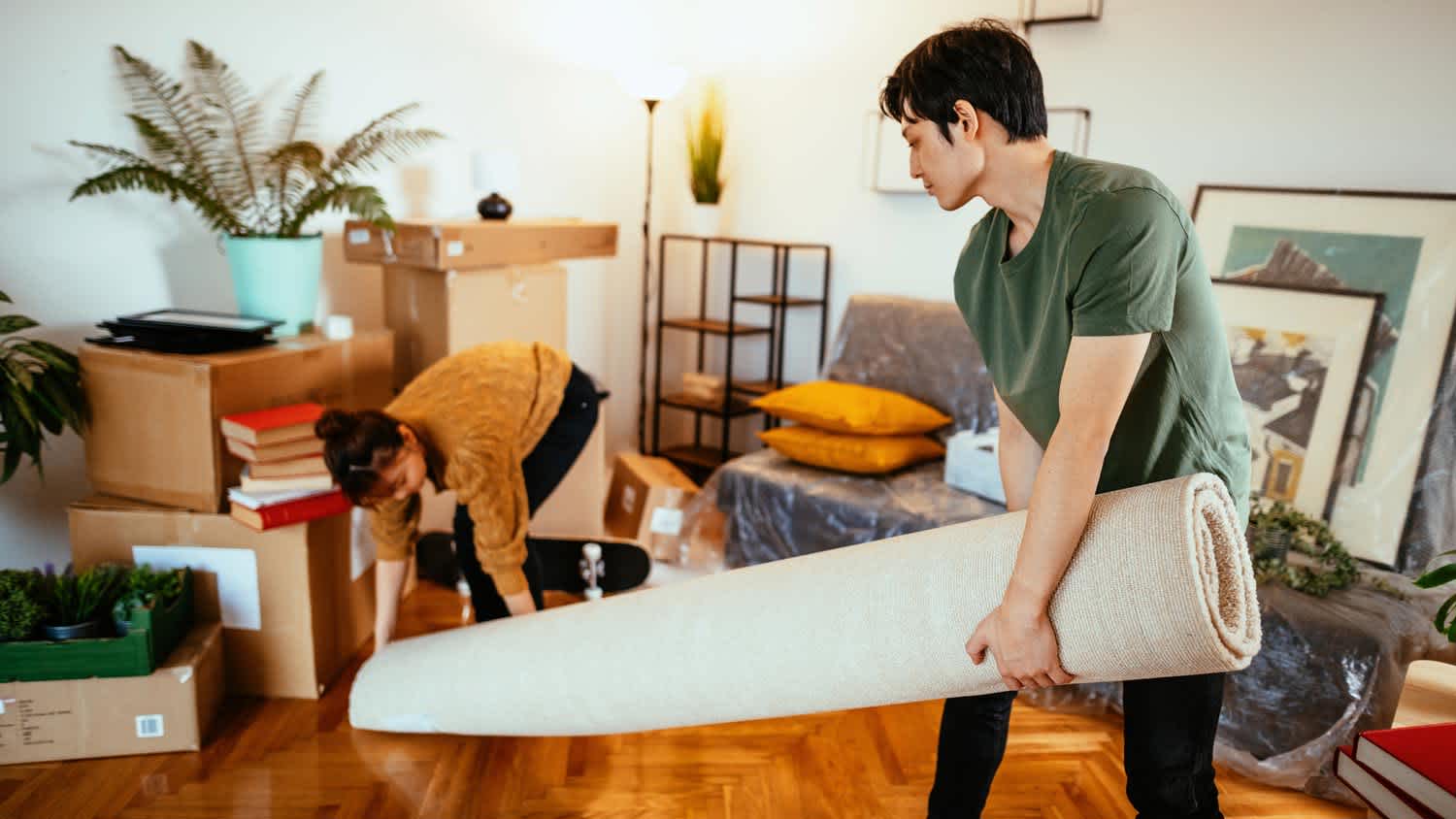 A young couple packing a rug
