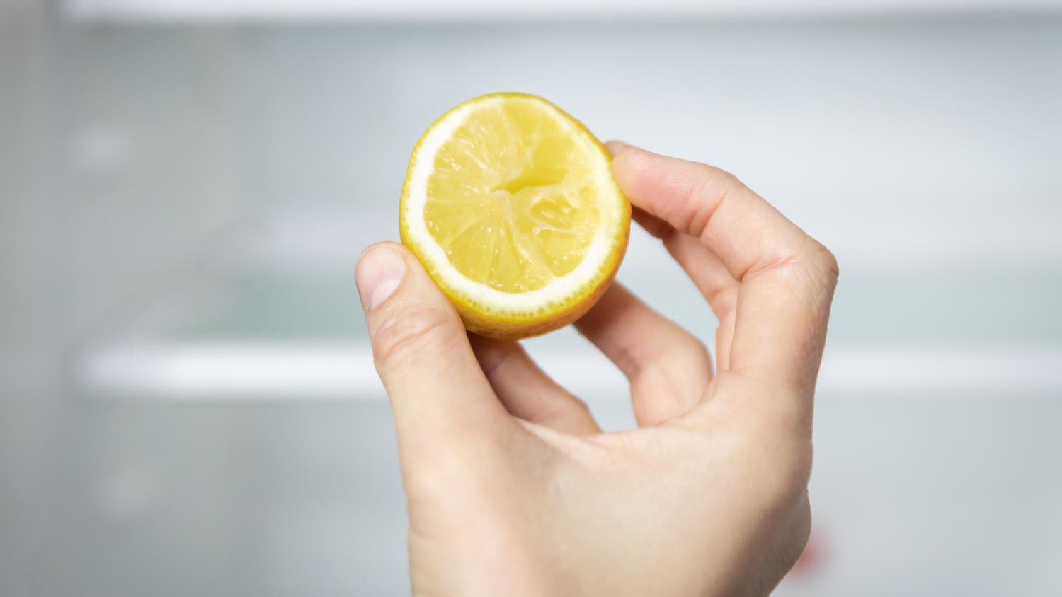 A woman holding a lemon