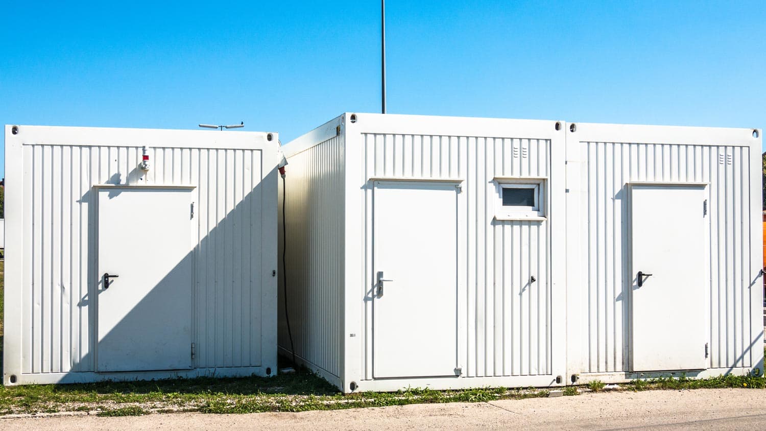 Three portable storage containers on a sunny day