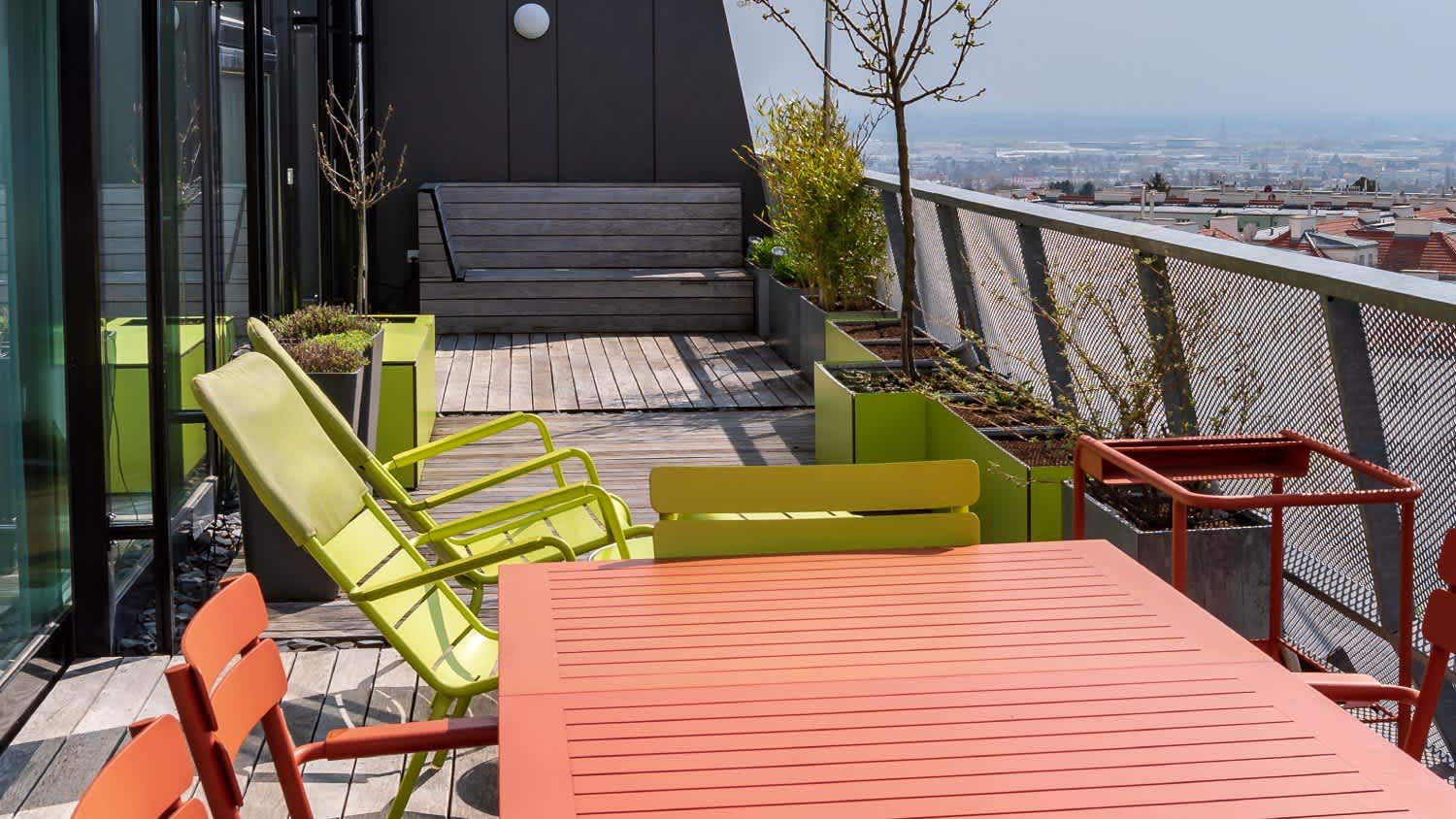Rooftop terrace with green and terracotta furniture