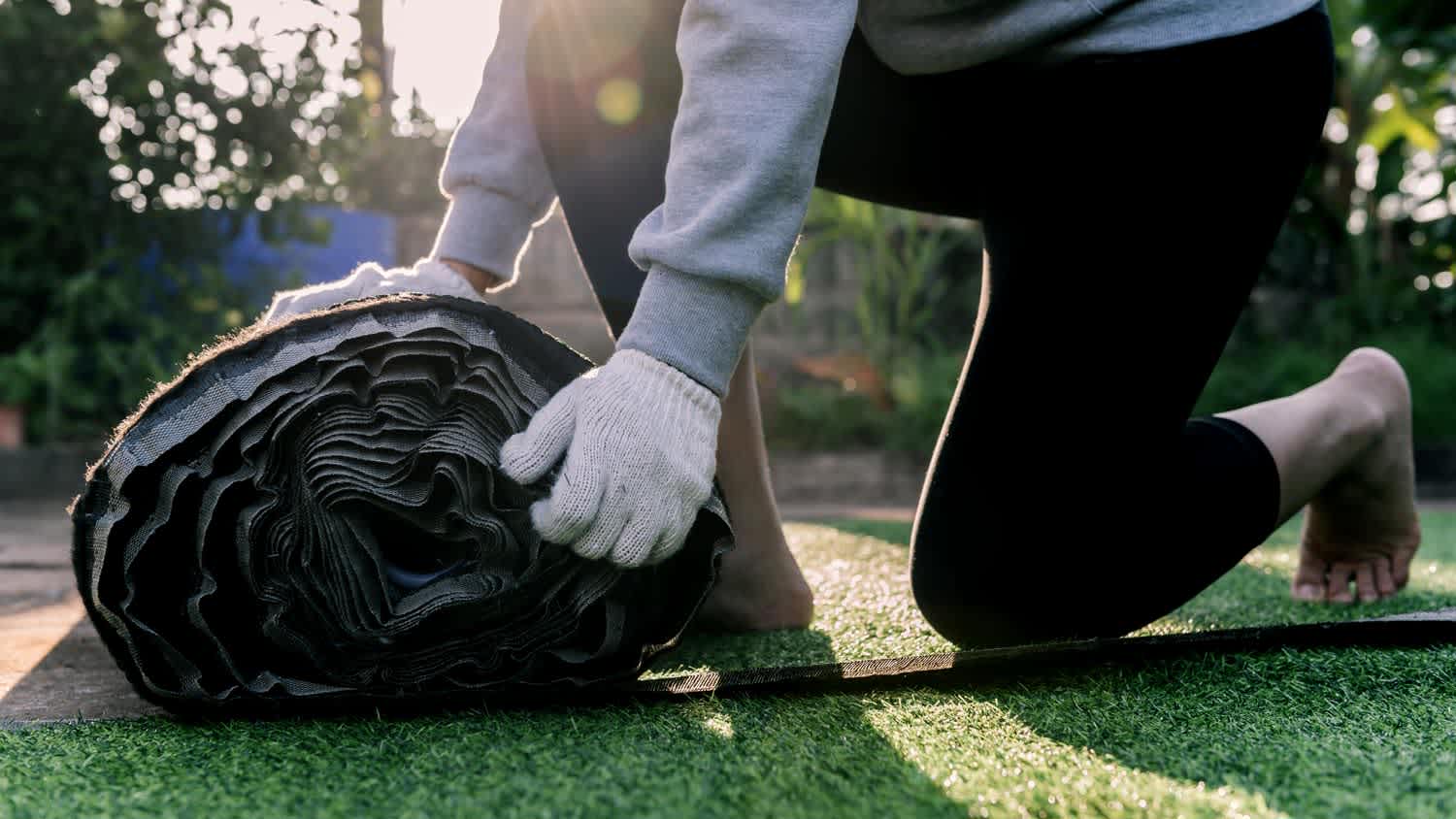 A man installing artificial turf