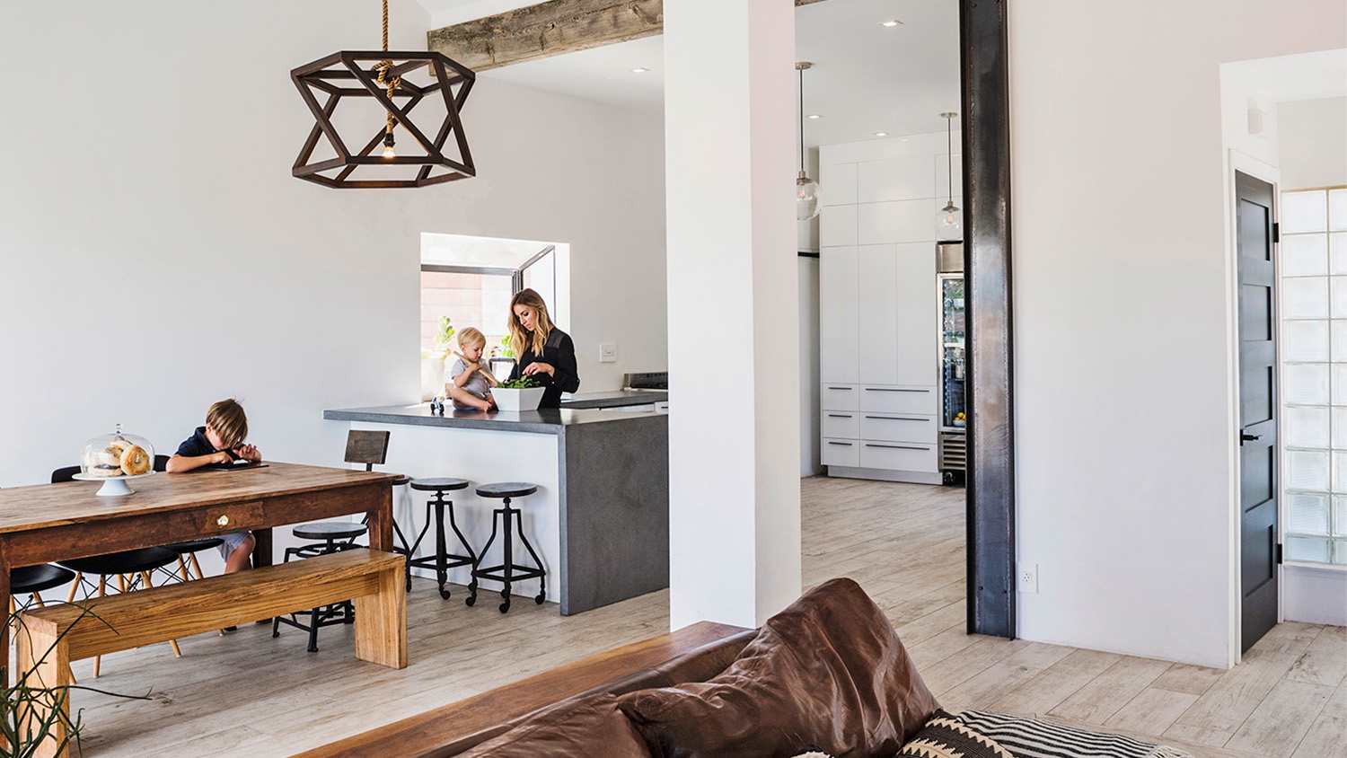 woman at home with children in the kitchen dining area