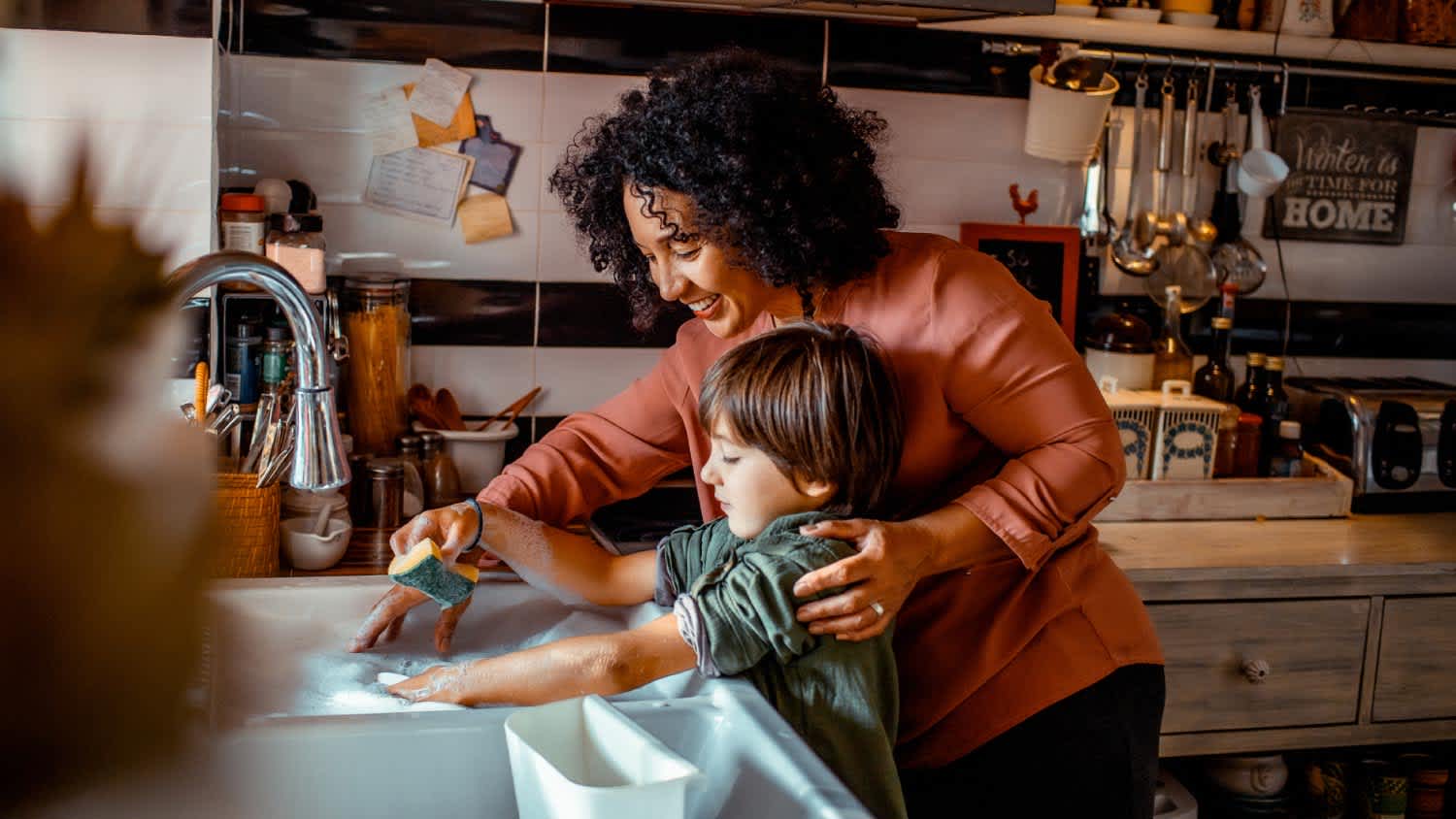 Mother and son washing dishes