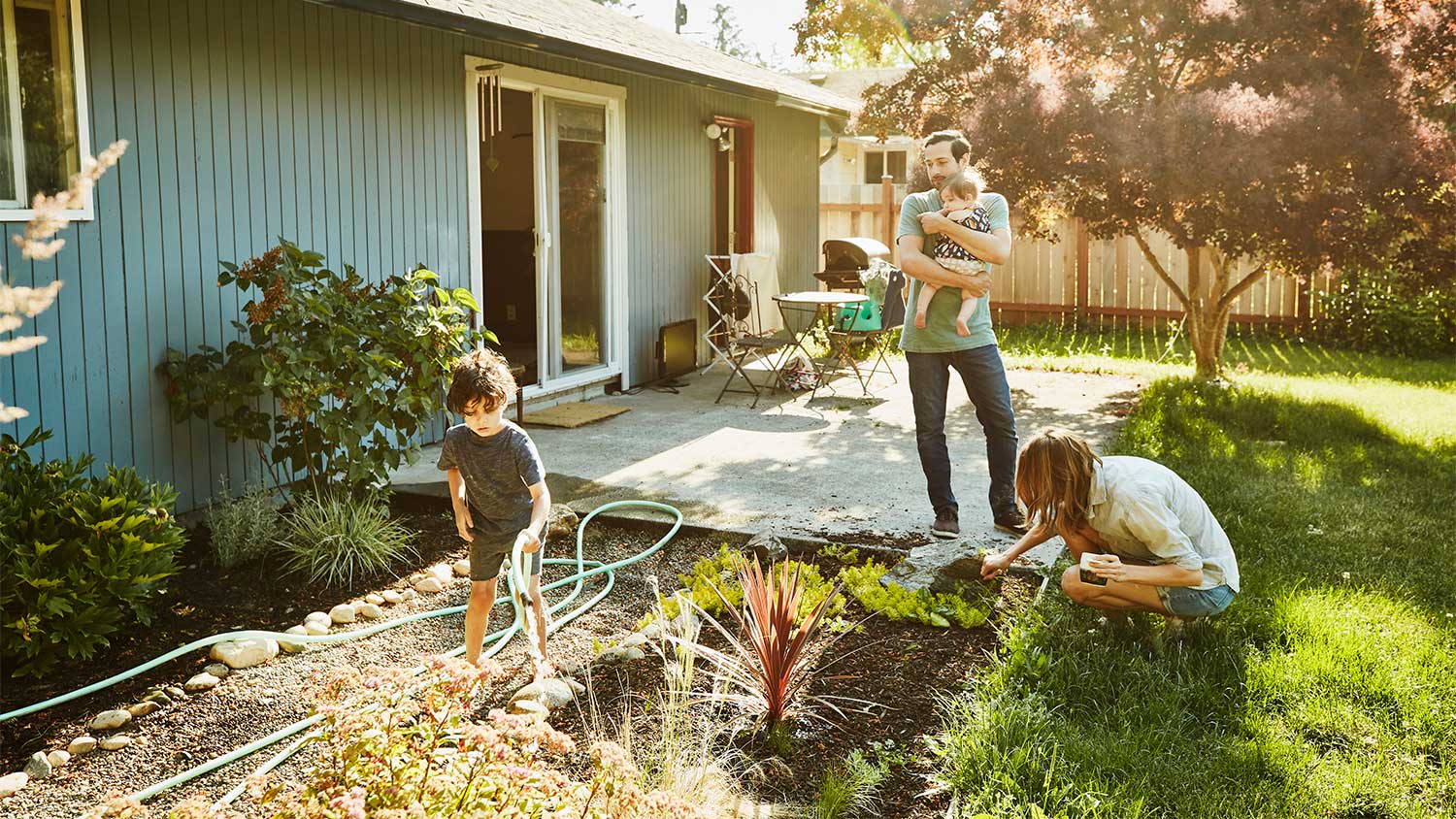 A family gardening in a backyard
