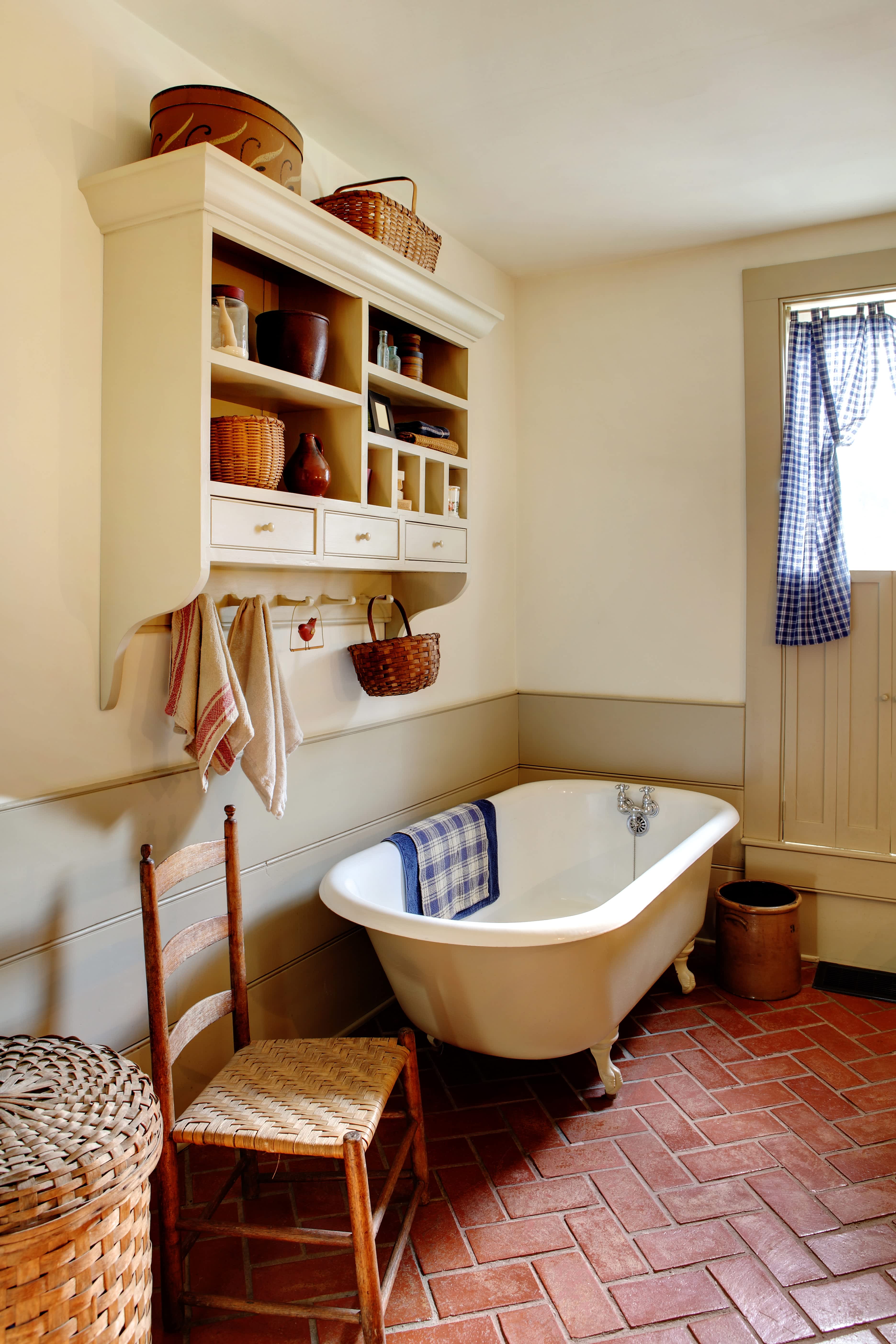 A small farmhouse style bathroom with brick flooring