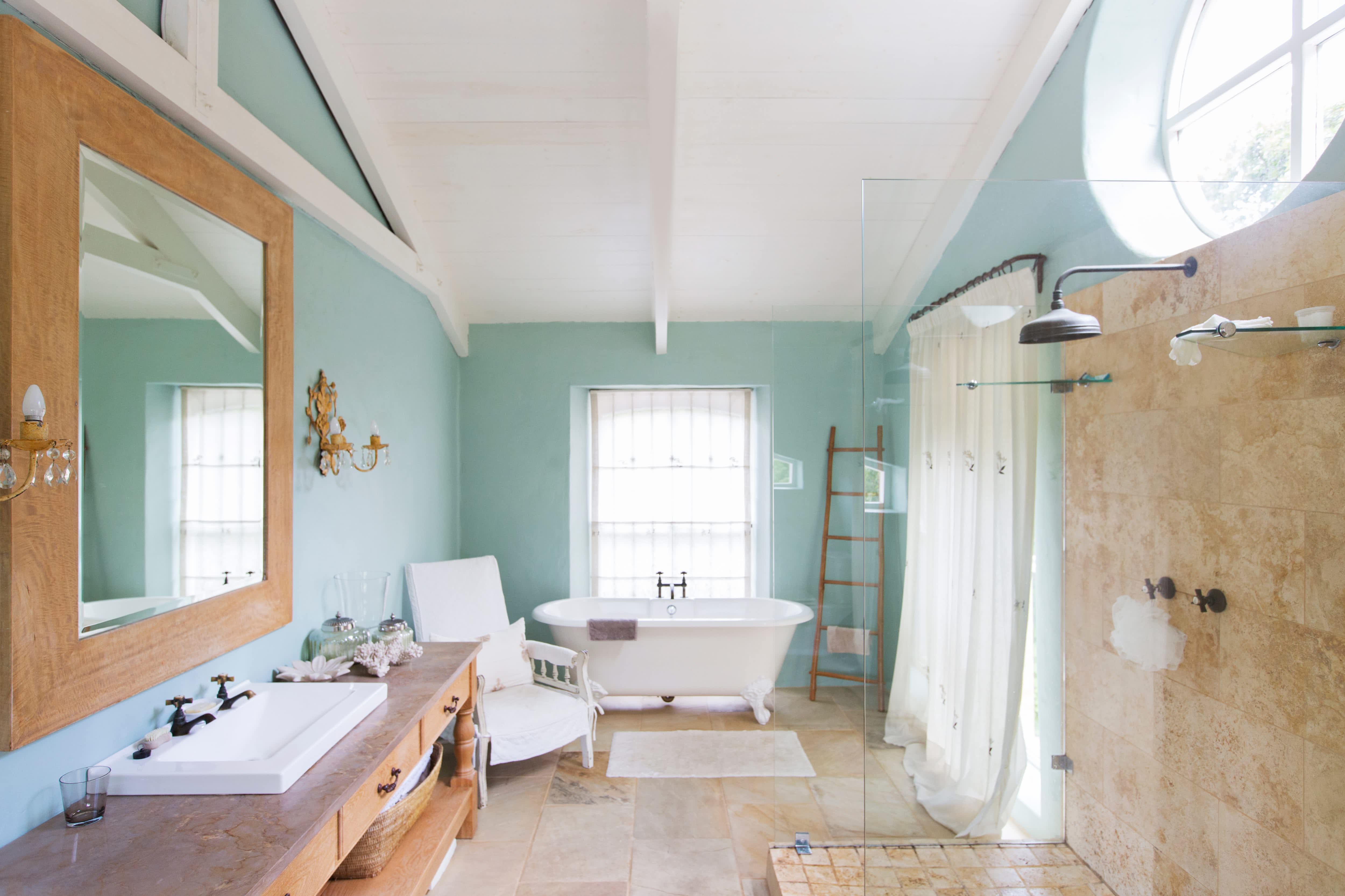 A bathroom with a wooden ladder and large chair