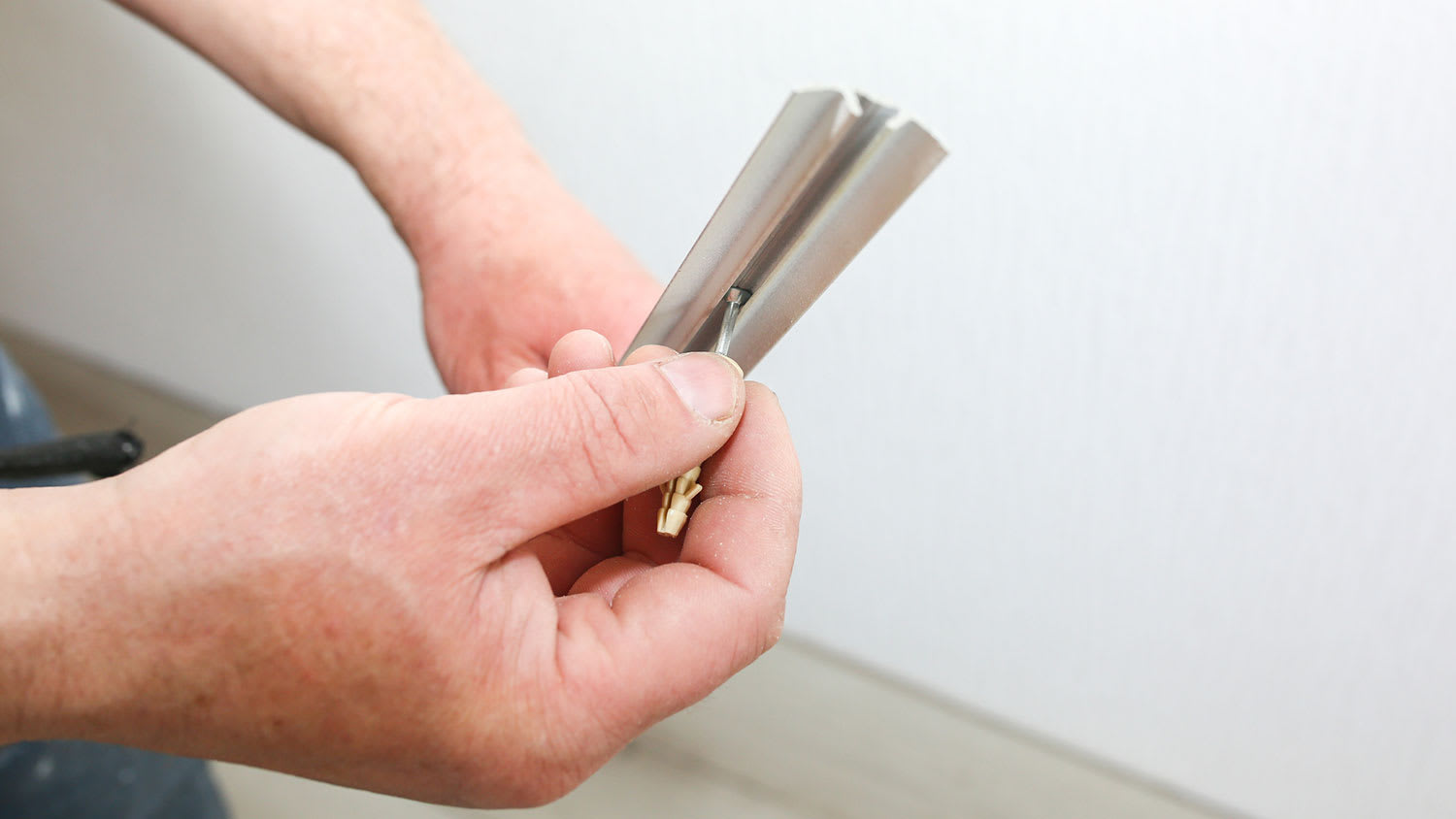 Man holding vinyl floor transition strip