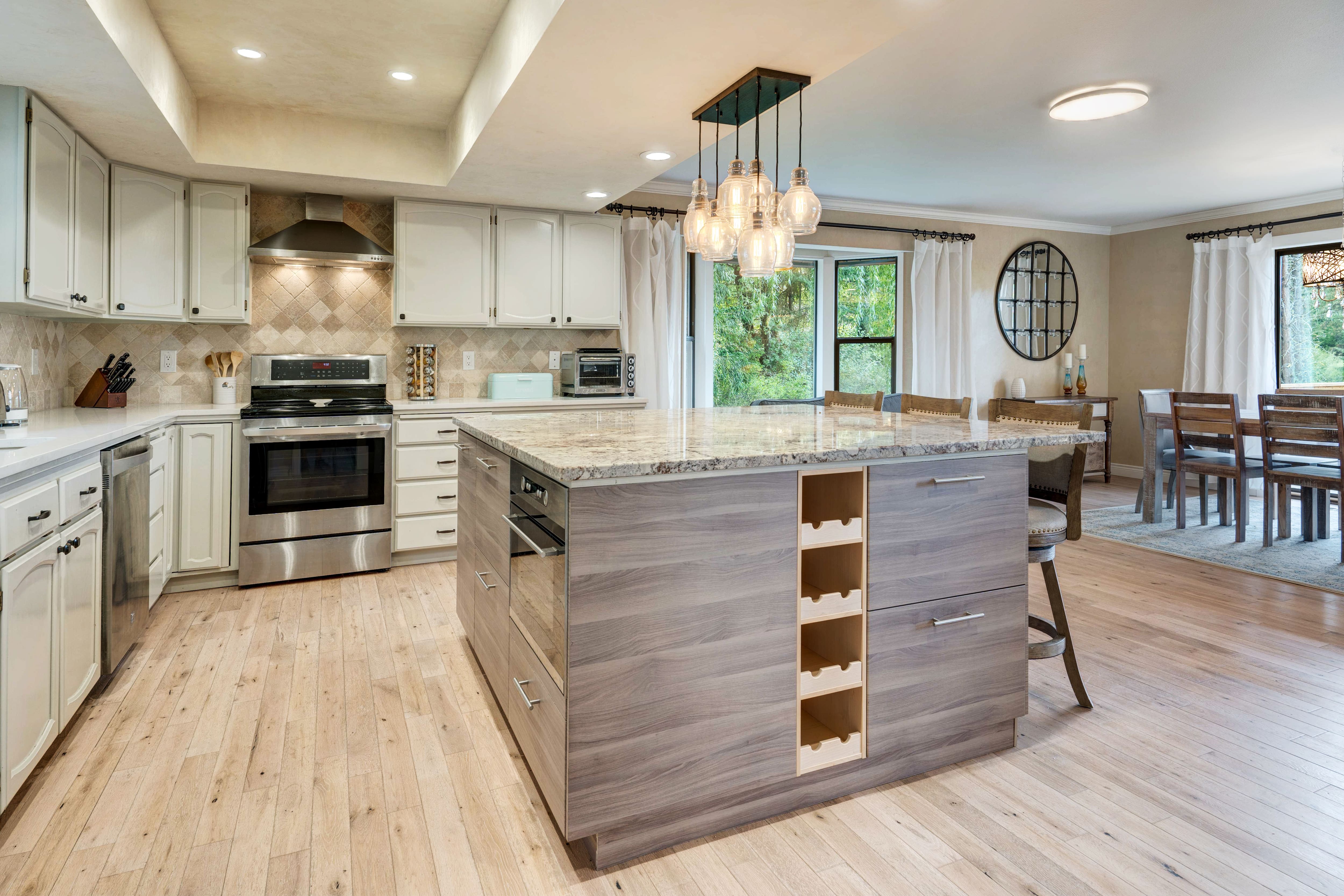 Large kitchen featuring wooden island and white cabinetry