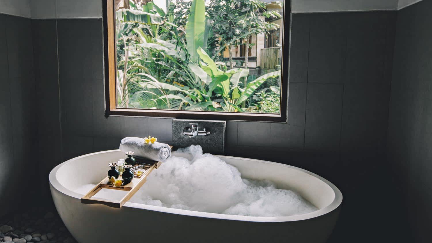 Bath with foam is filling with water