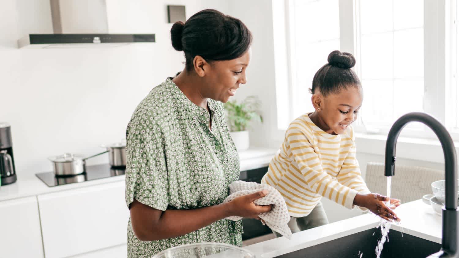 mother and daughter washing dishes