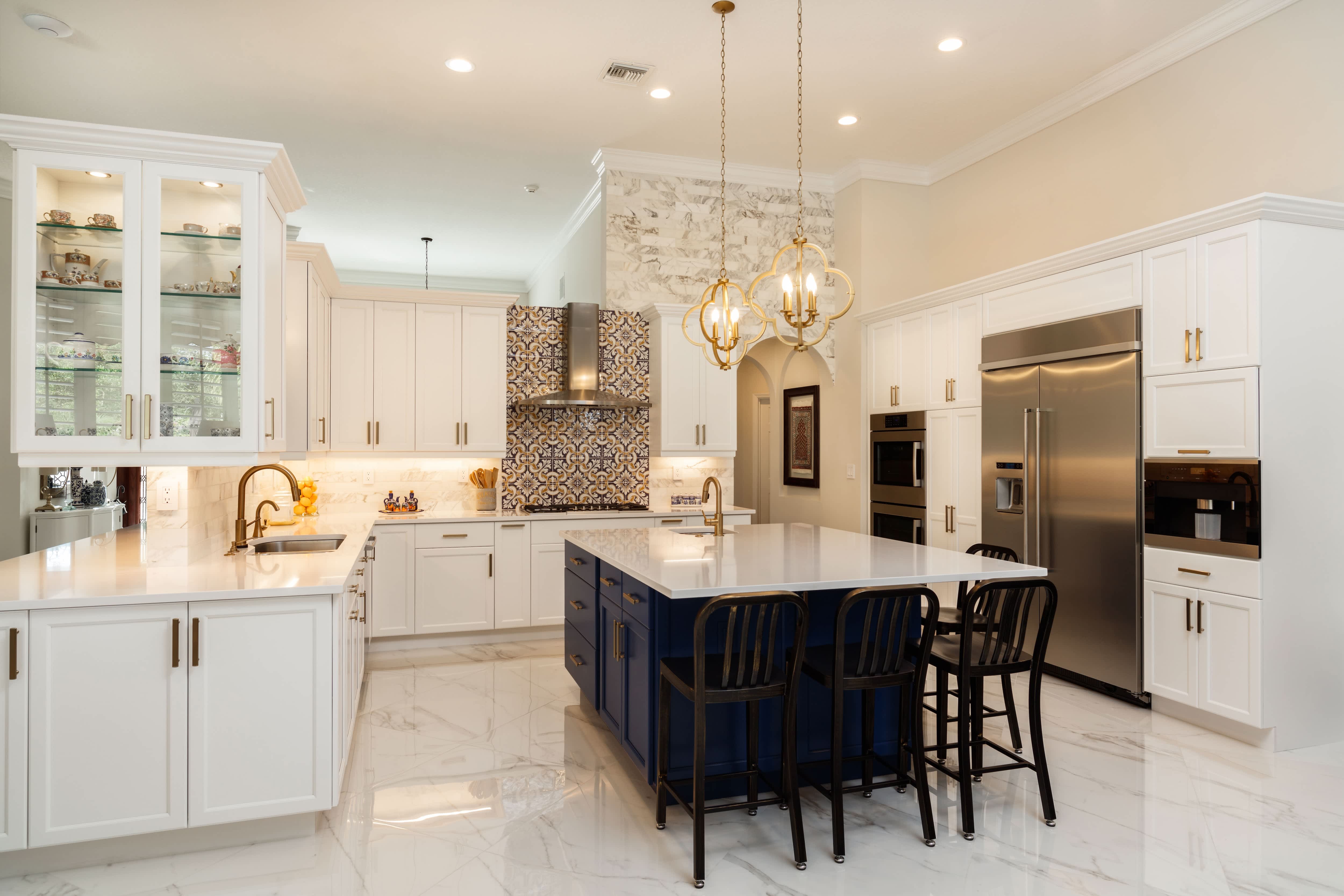 White kitchen cabinets and navy blue island