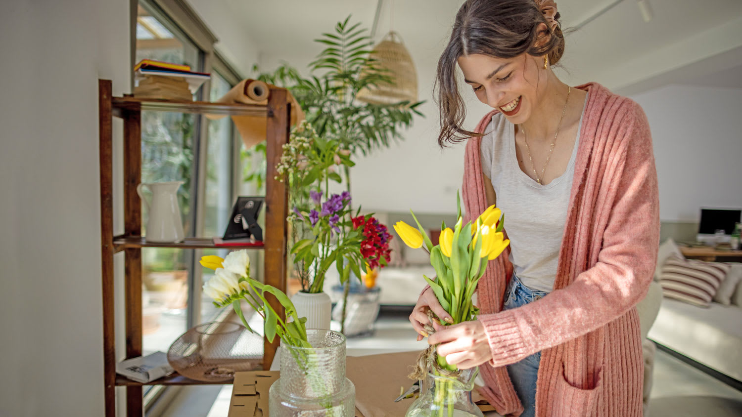 woman arranging tulips in home