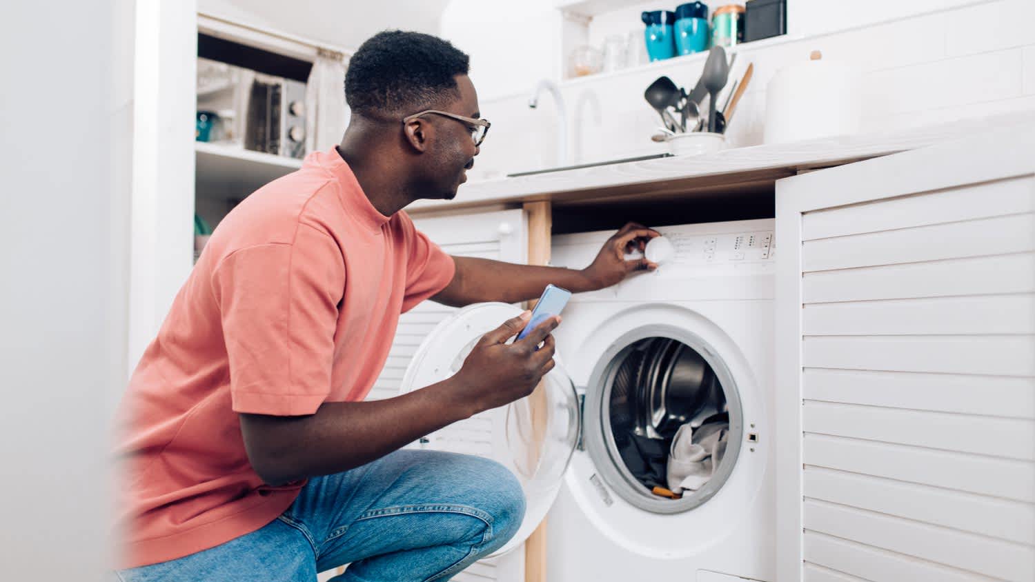 man turning on the washing machine