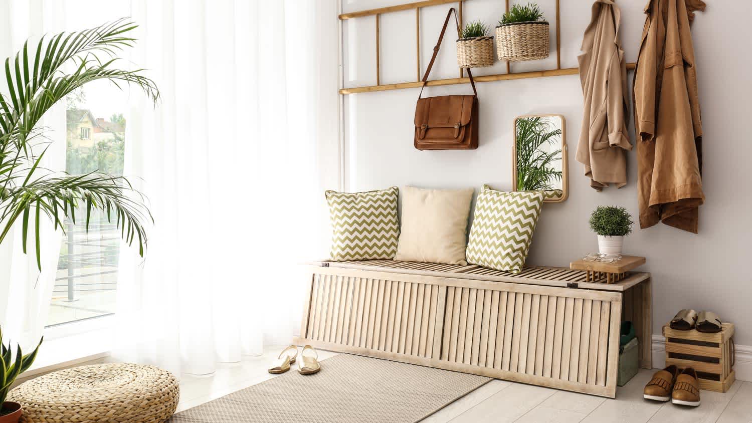 A stylish storage bench in the sunny hallway of a house