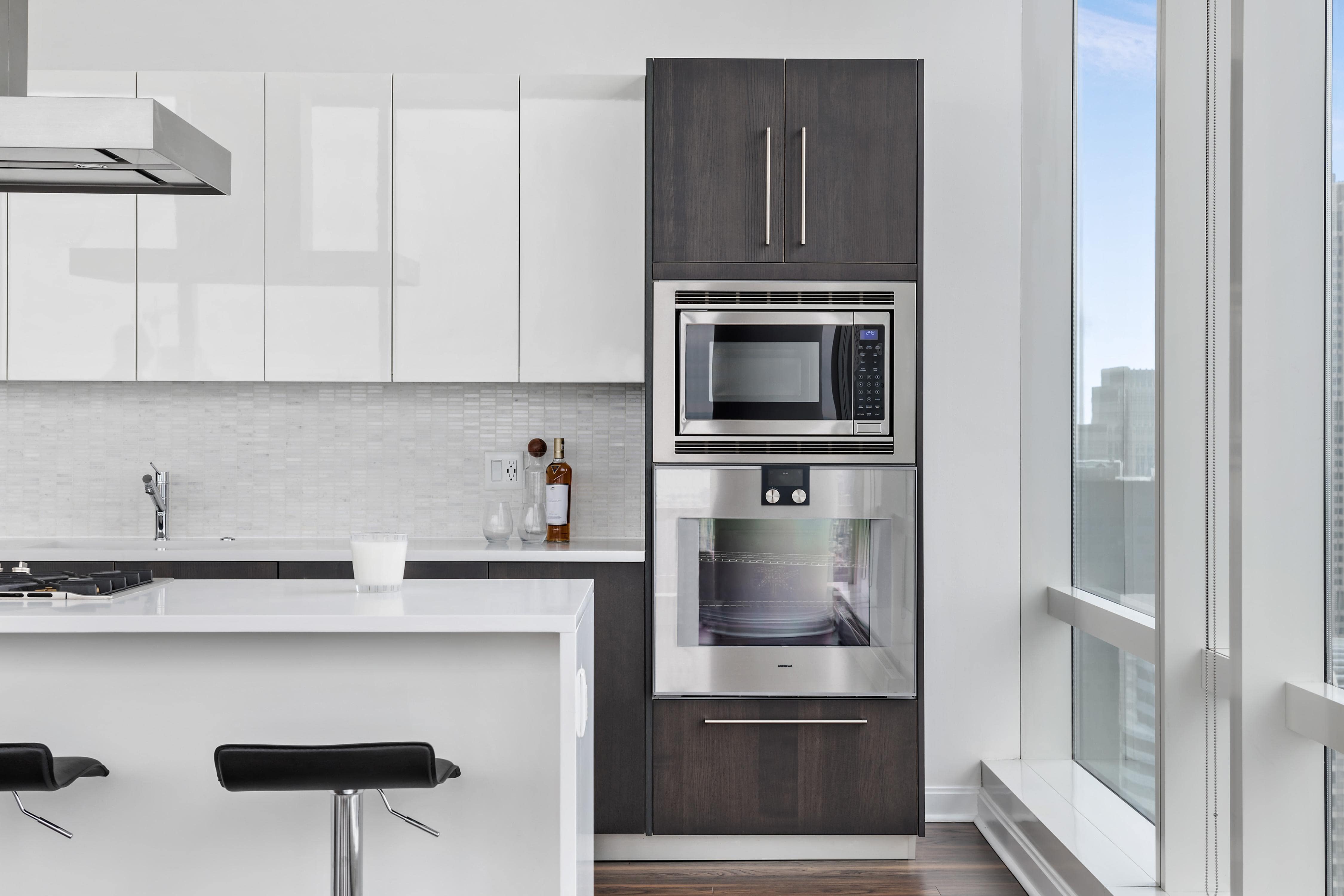 White high gloss cabinets and two-toned wooden cabinets