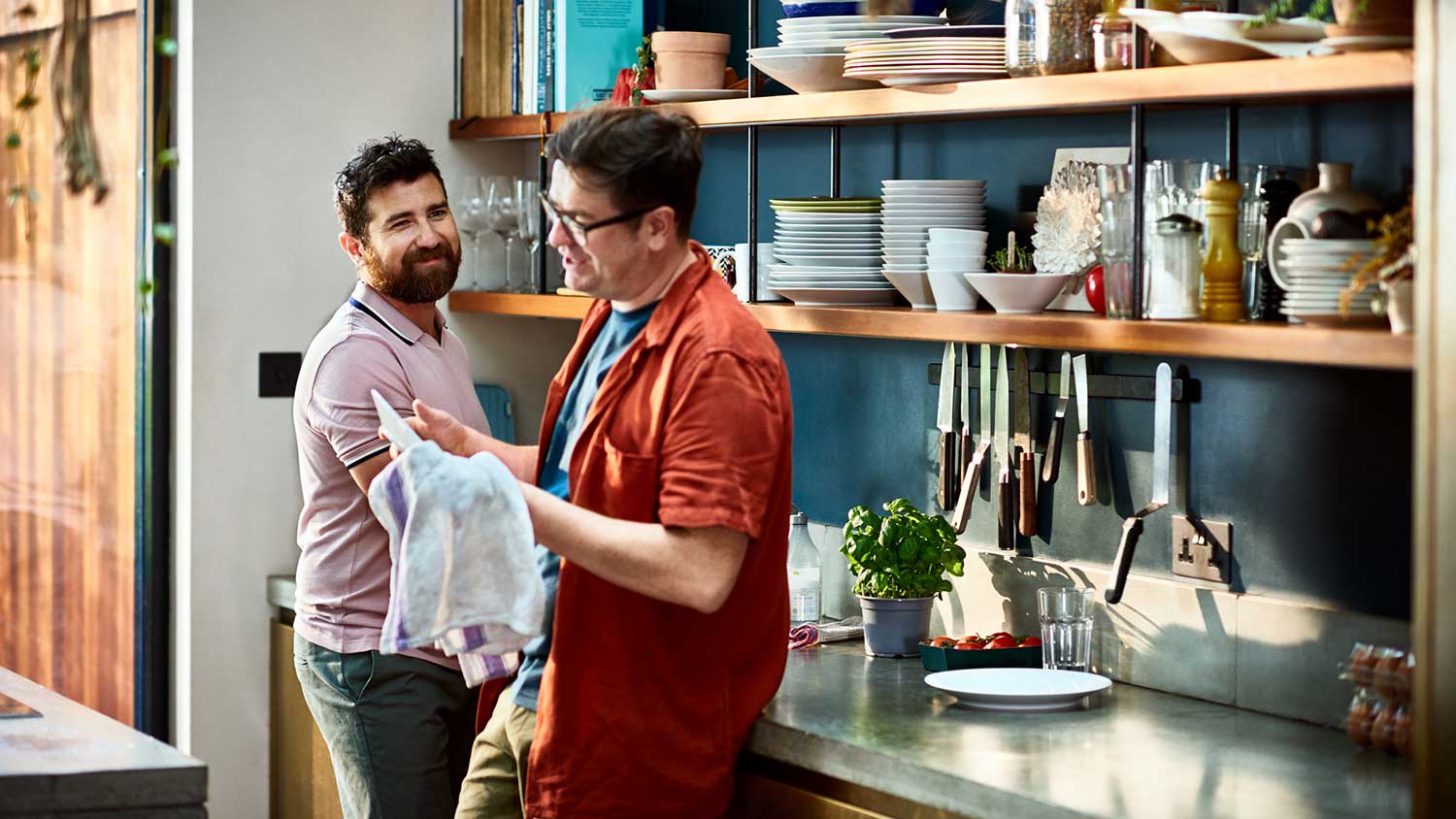 Couple chatting while washing dishes
