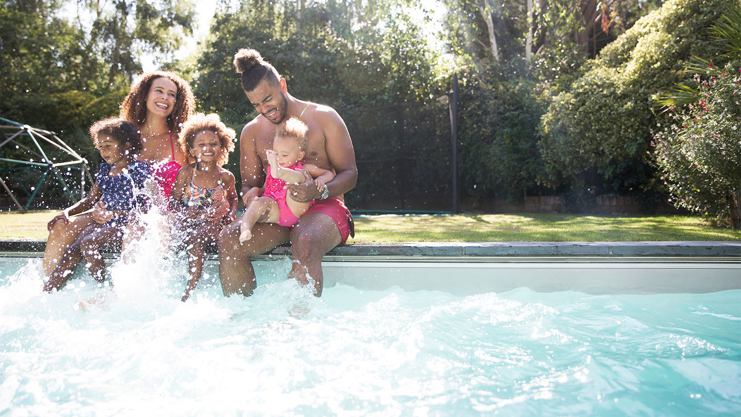 family playing in swimming pool
