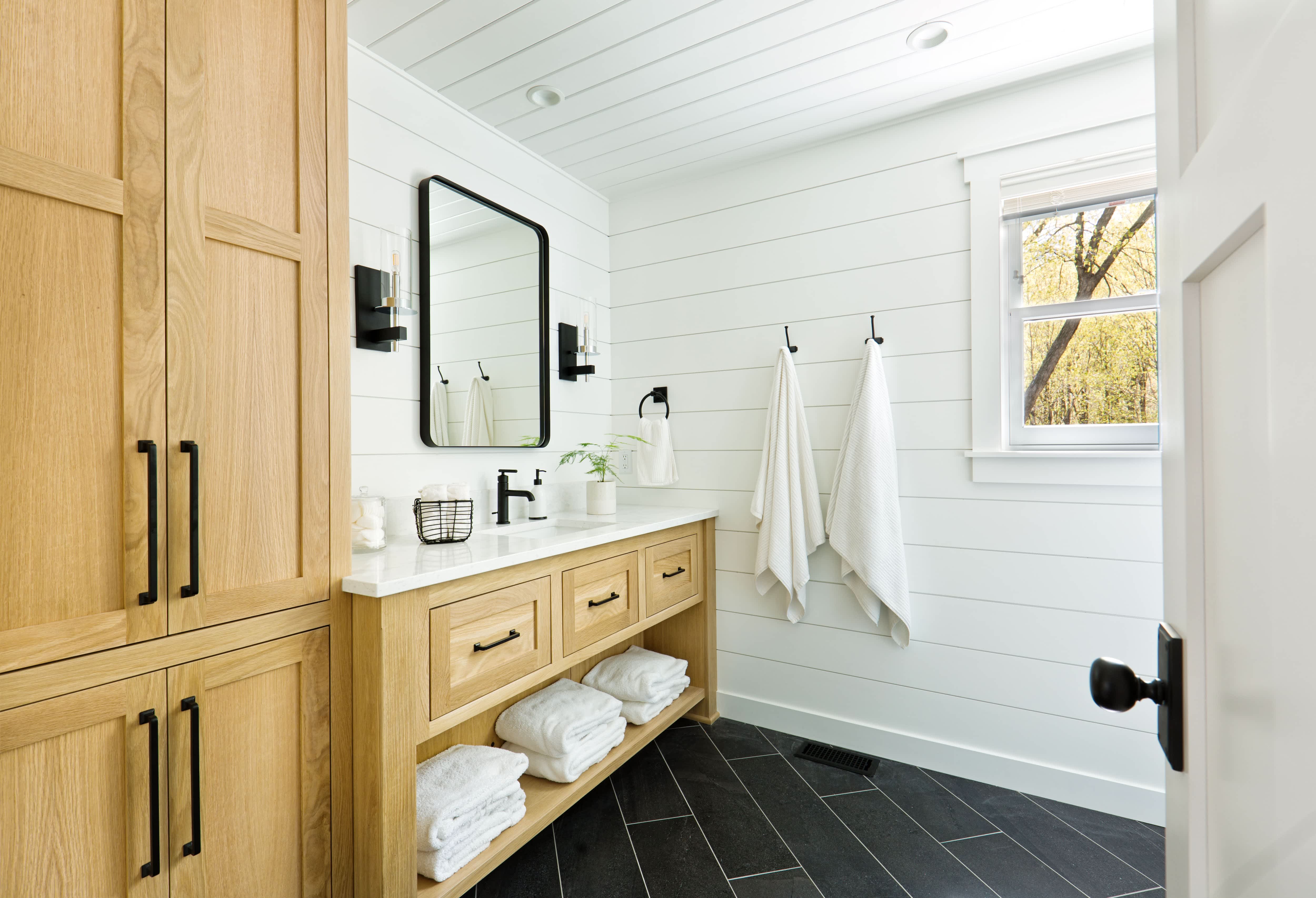 A clean bathroom with white shiplap walls