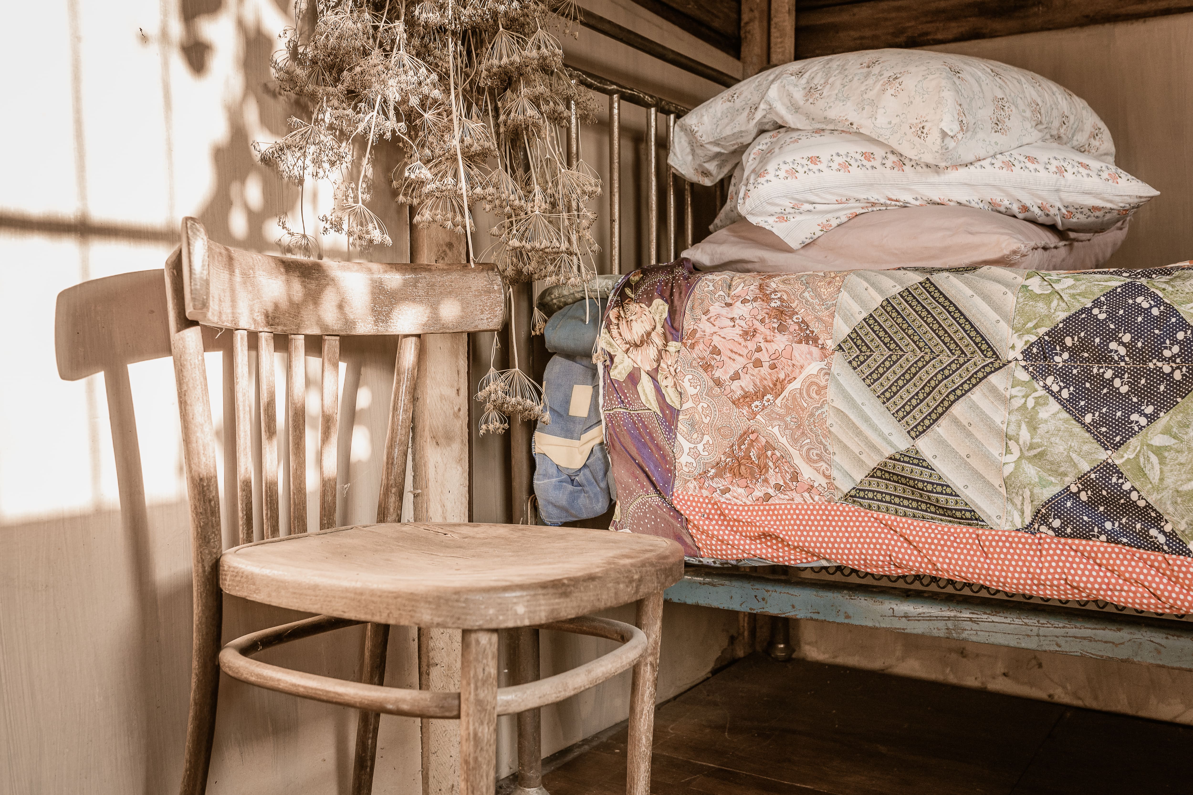 Patchwork quilt on bed in farmhouse bedroom