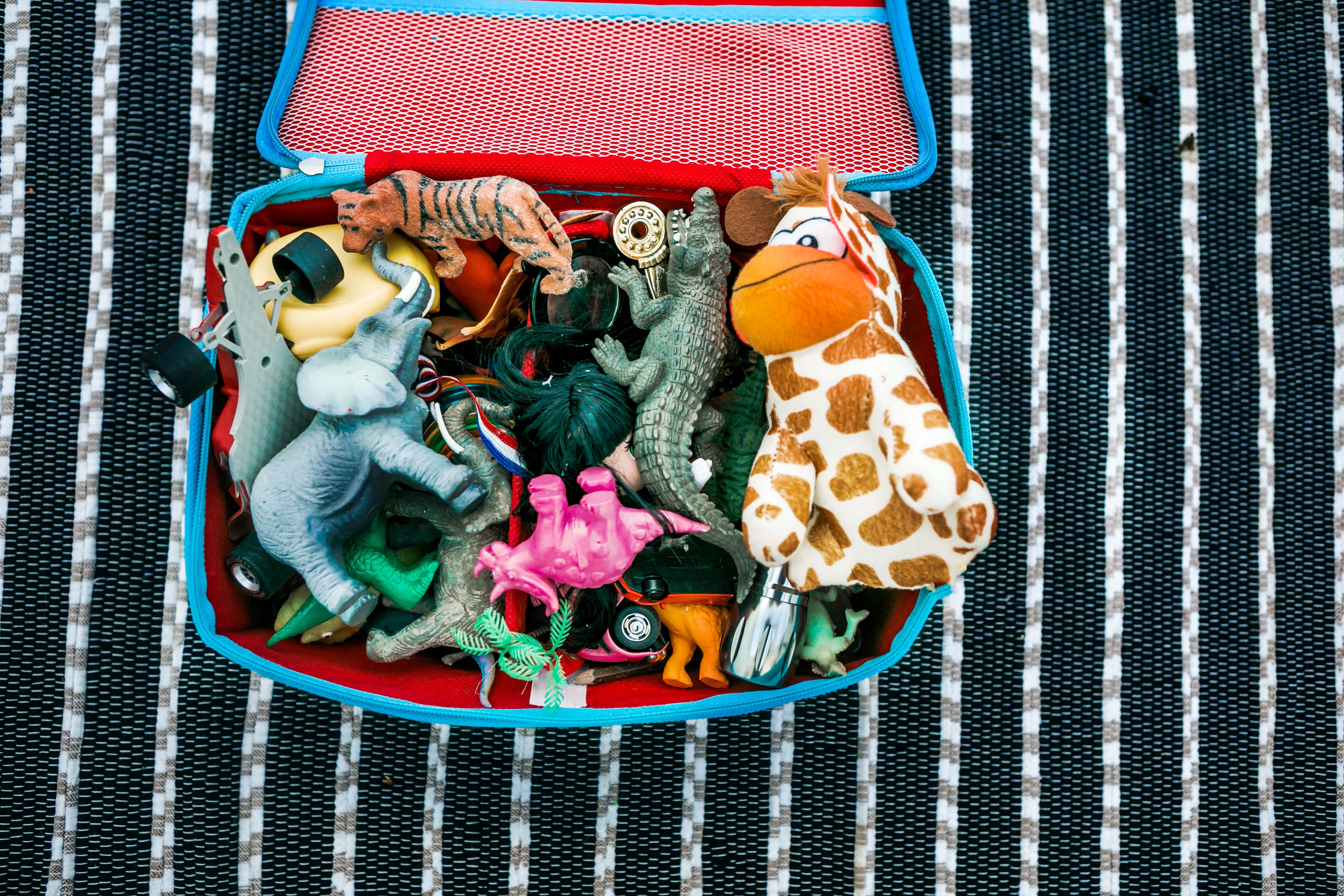 A small kid’s suitcase filled with toys