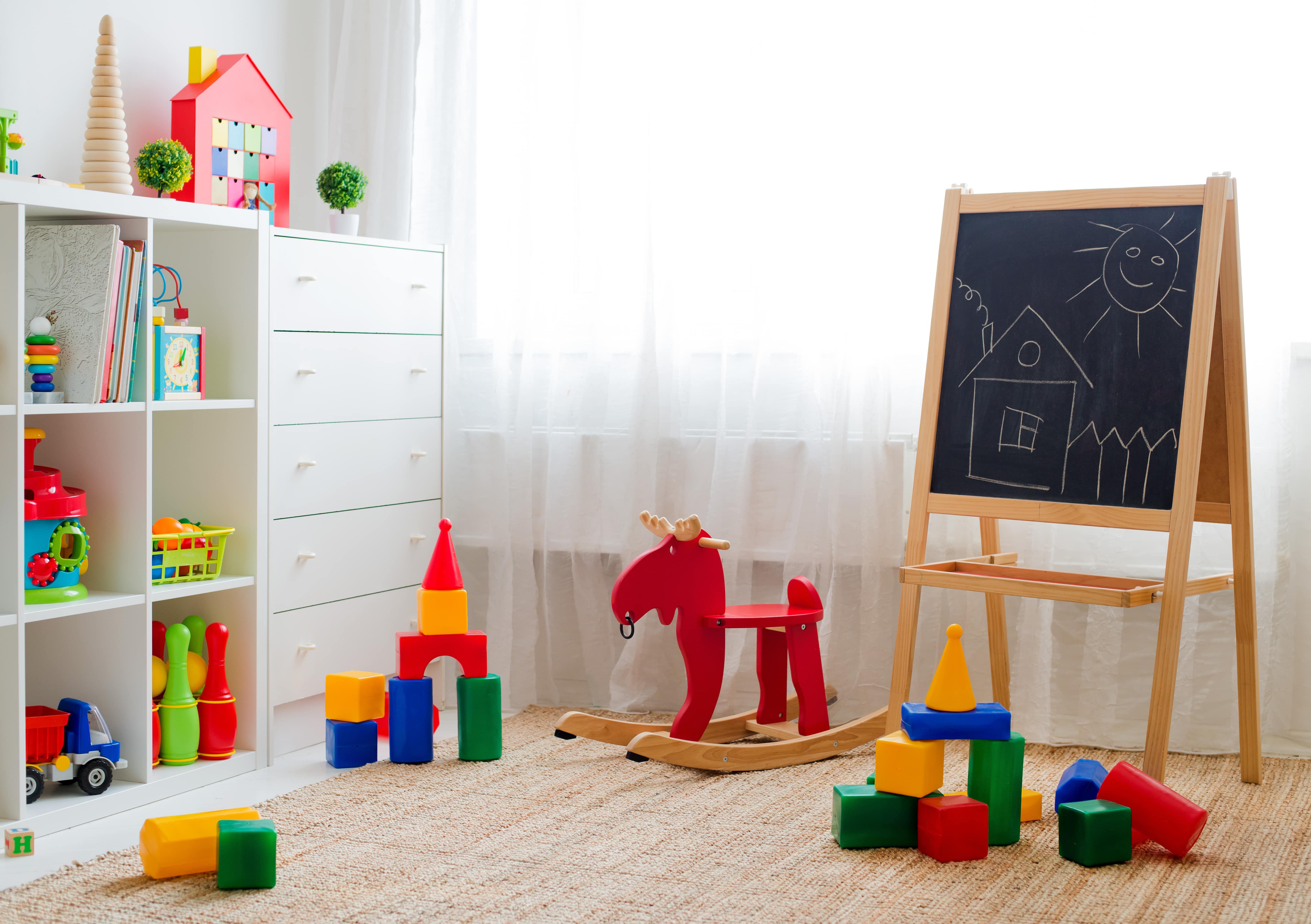 A bright children’s playroom with neatly organized colorful toys Craft supplies