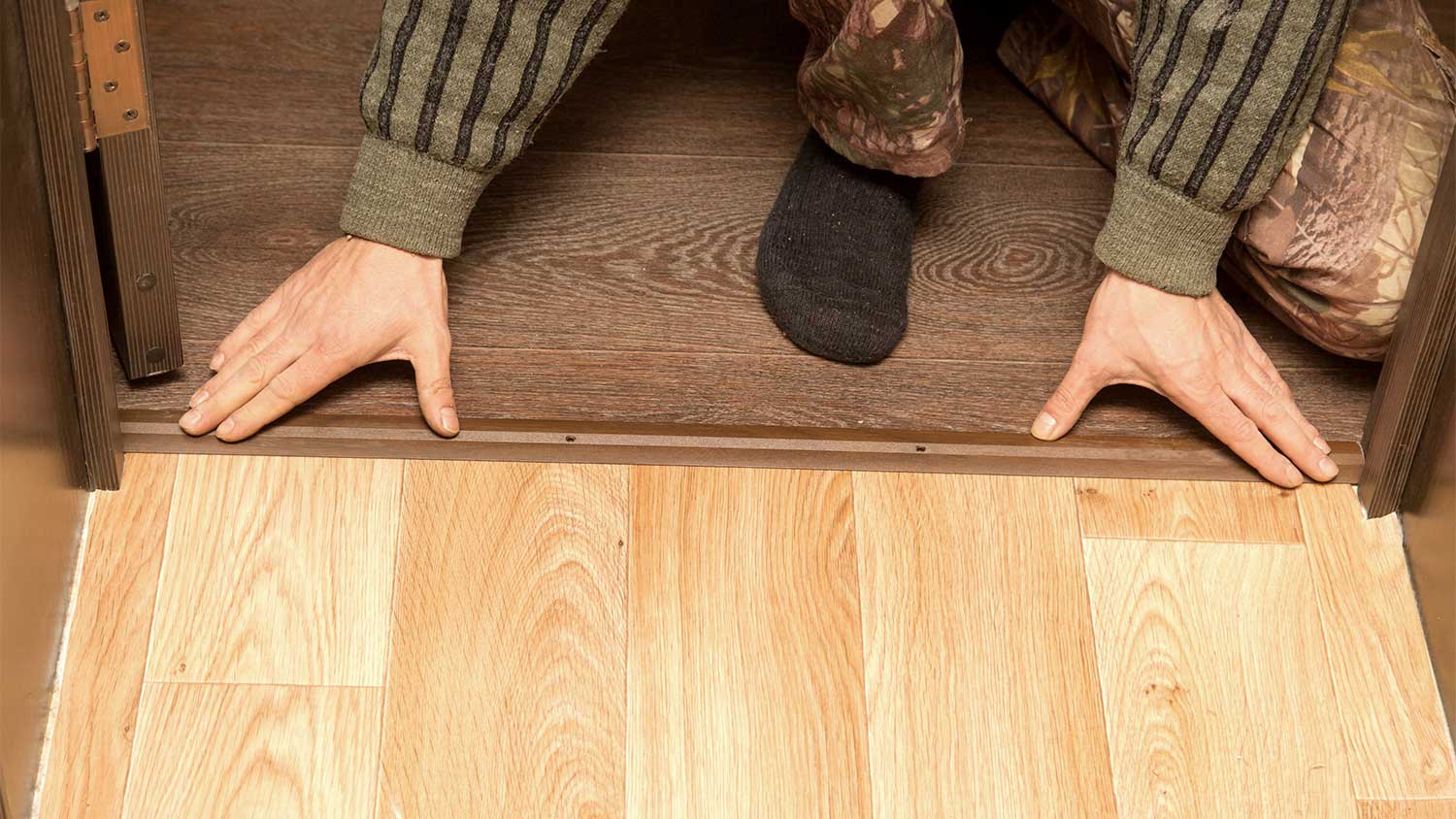 A man installs a threshold