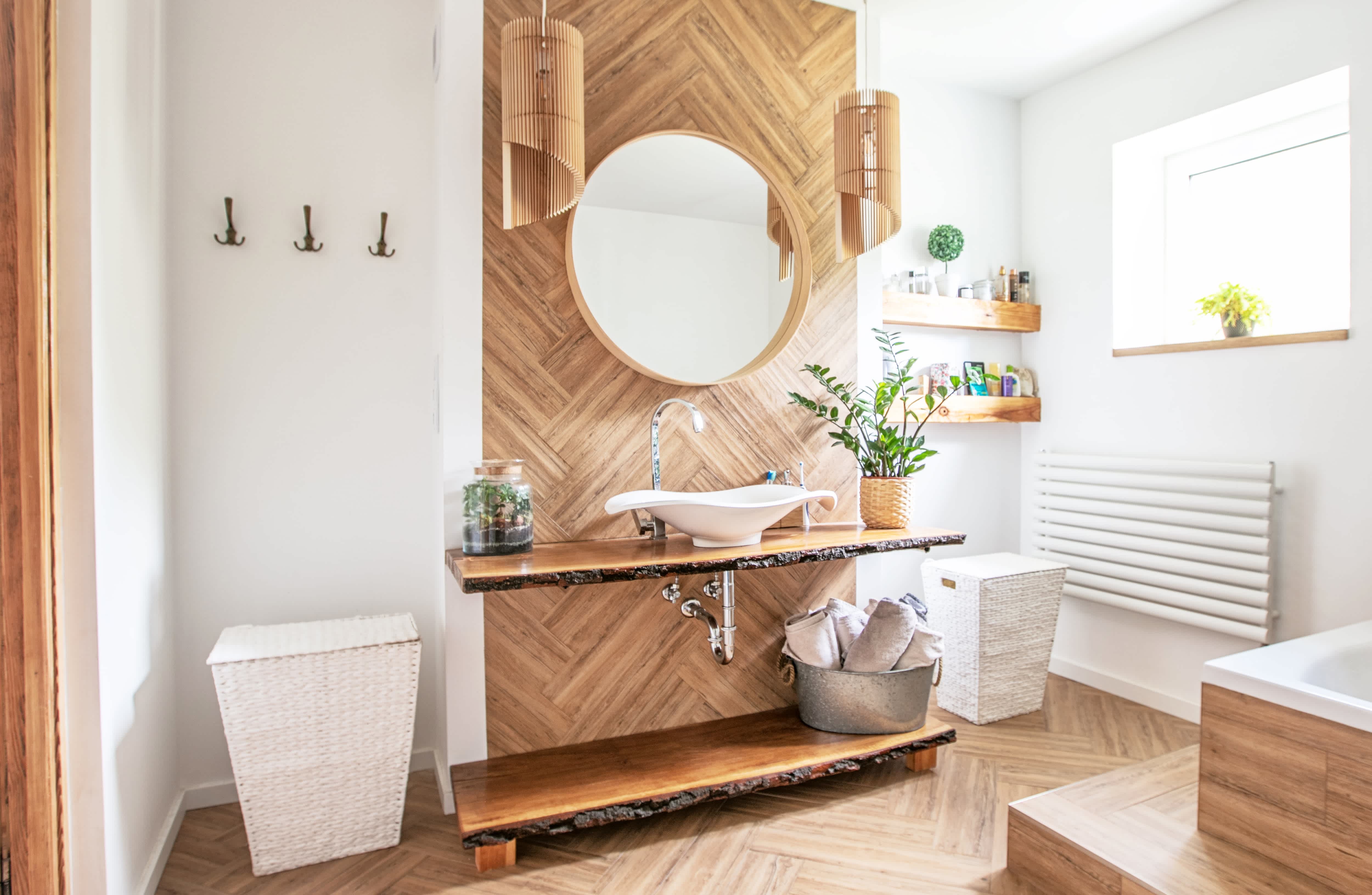 Bohemian bathroom design with circular mirror